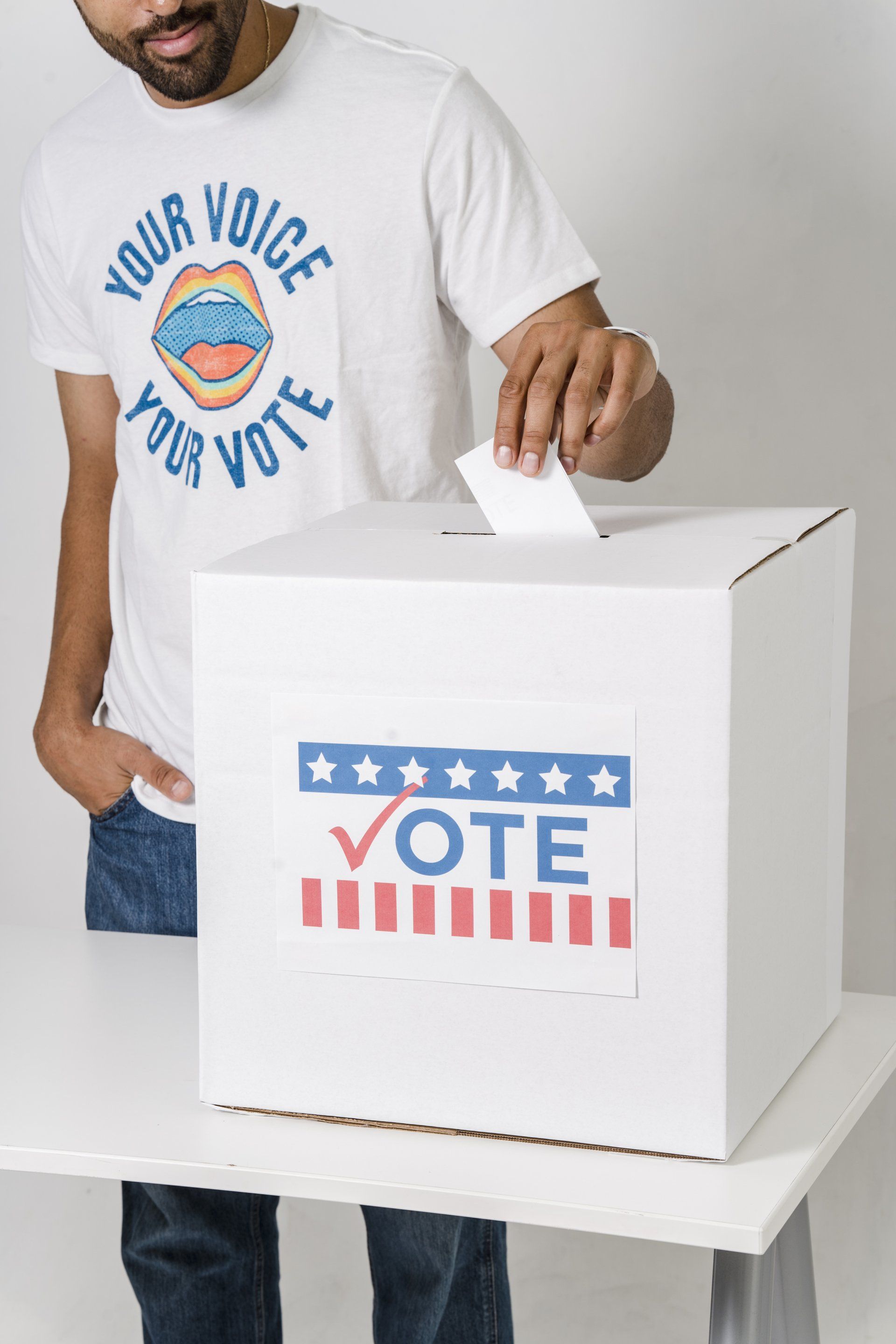 A man places his ballot into a ballot box