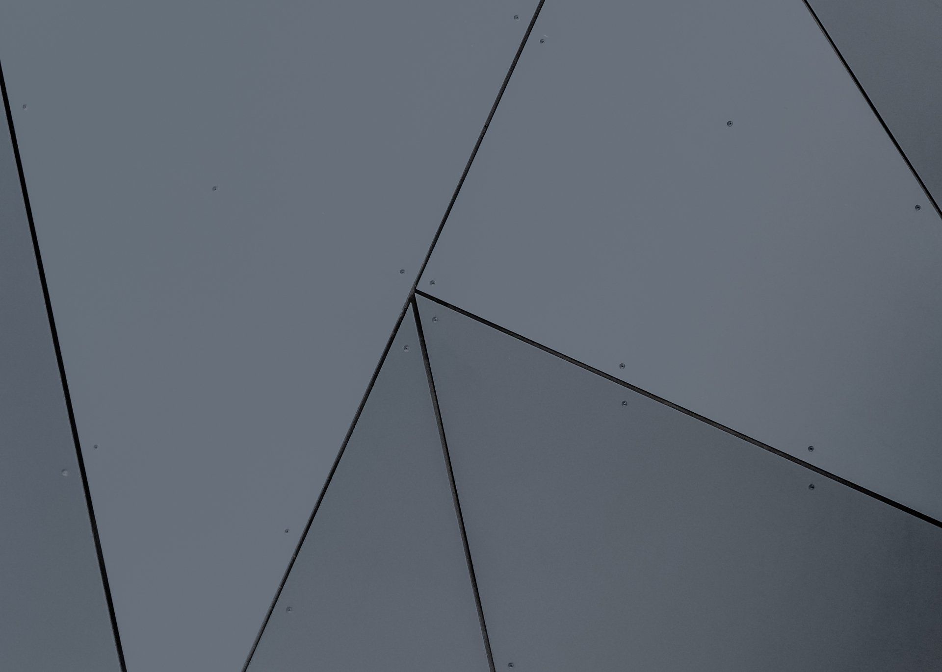 a close up of a gray wall with triangles on it .