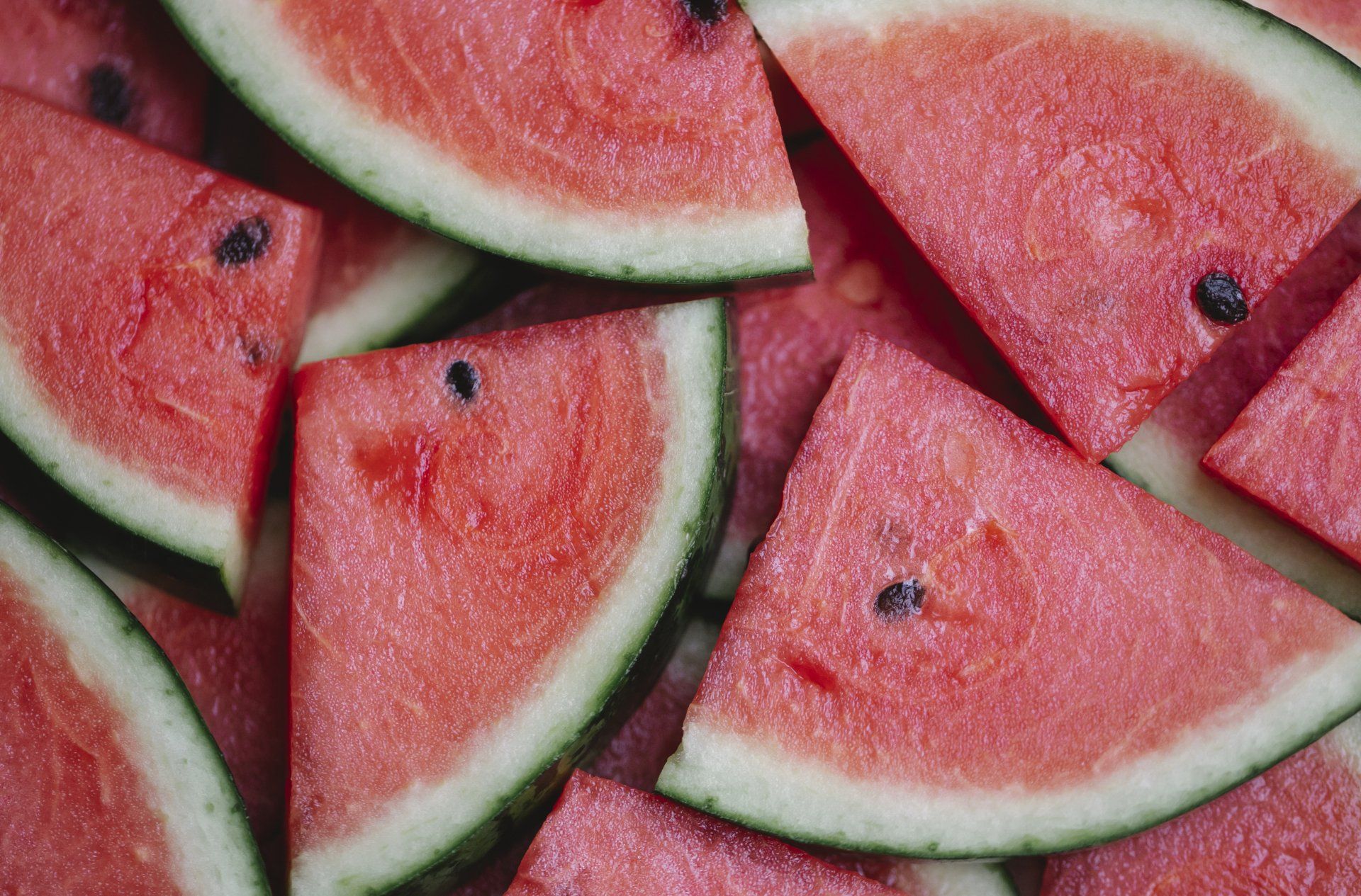 A pile of watermelon slices on a table.