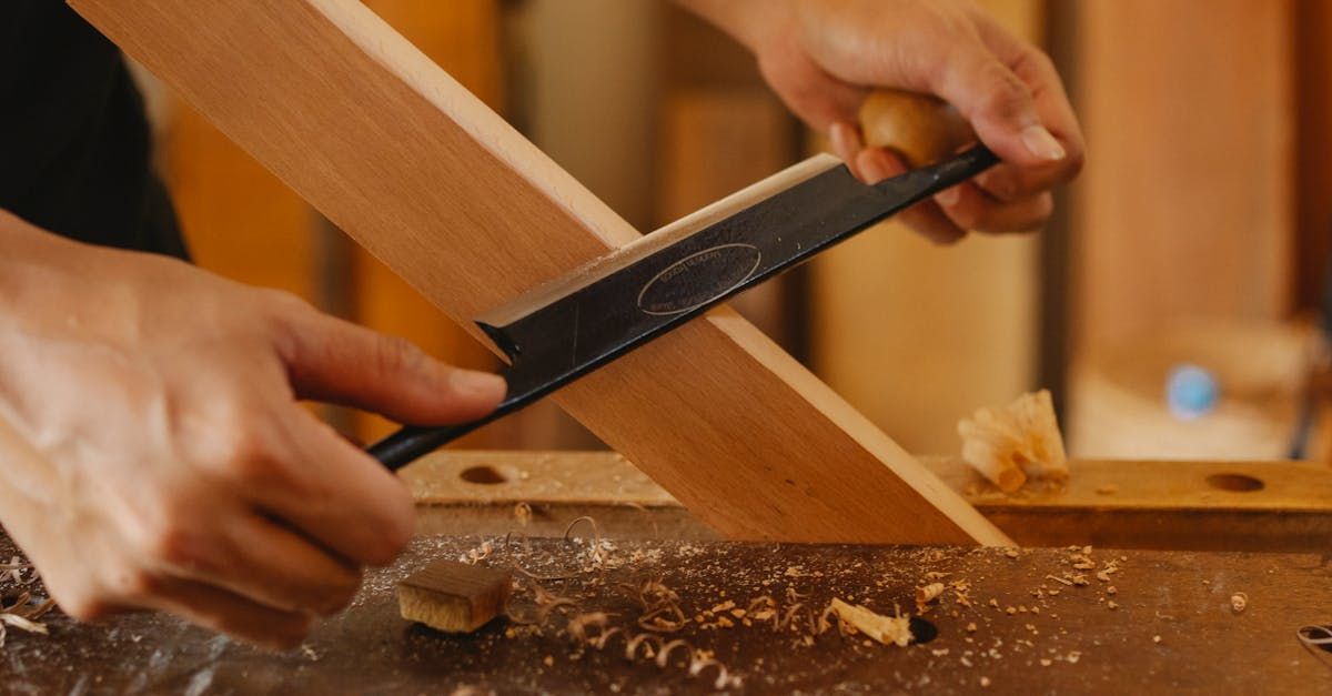 A person is working on a piece of wood with a tool.