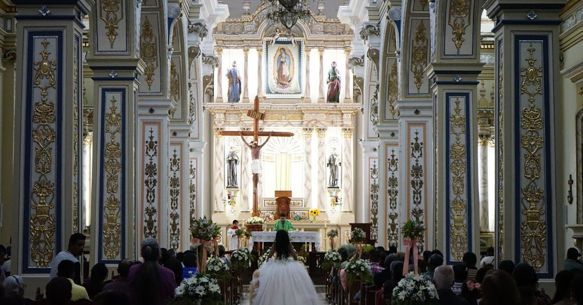 A woman in a wedding dress is walking down the aisle of a church.