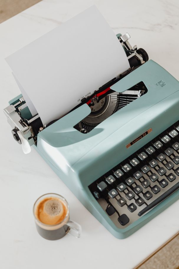 image of a typewriter and a cup of coffee