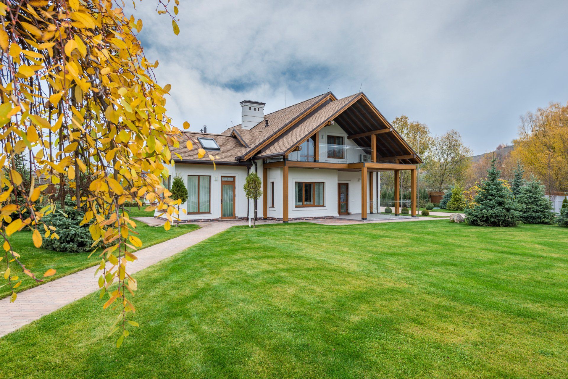 a large house with a lush green lawn in front of it .