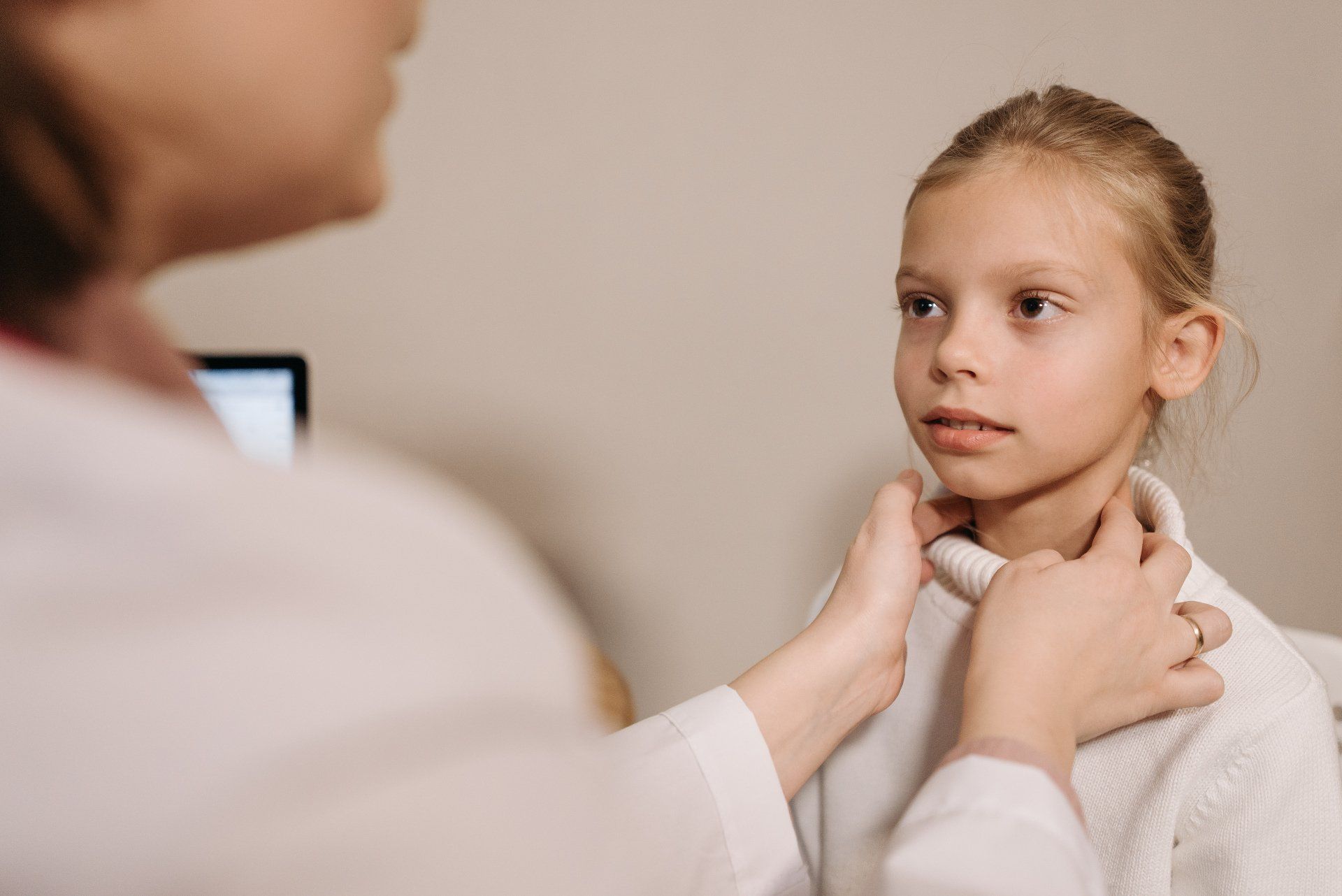 Doctor checking a kid with tonsils