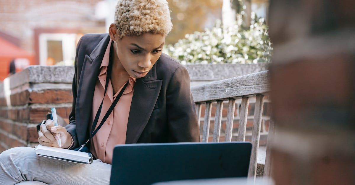 A woman is sitting in front of a laptop computer.