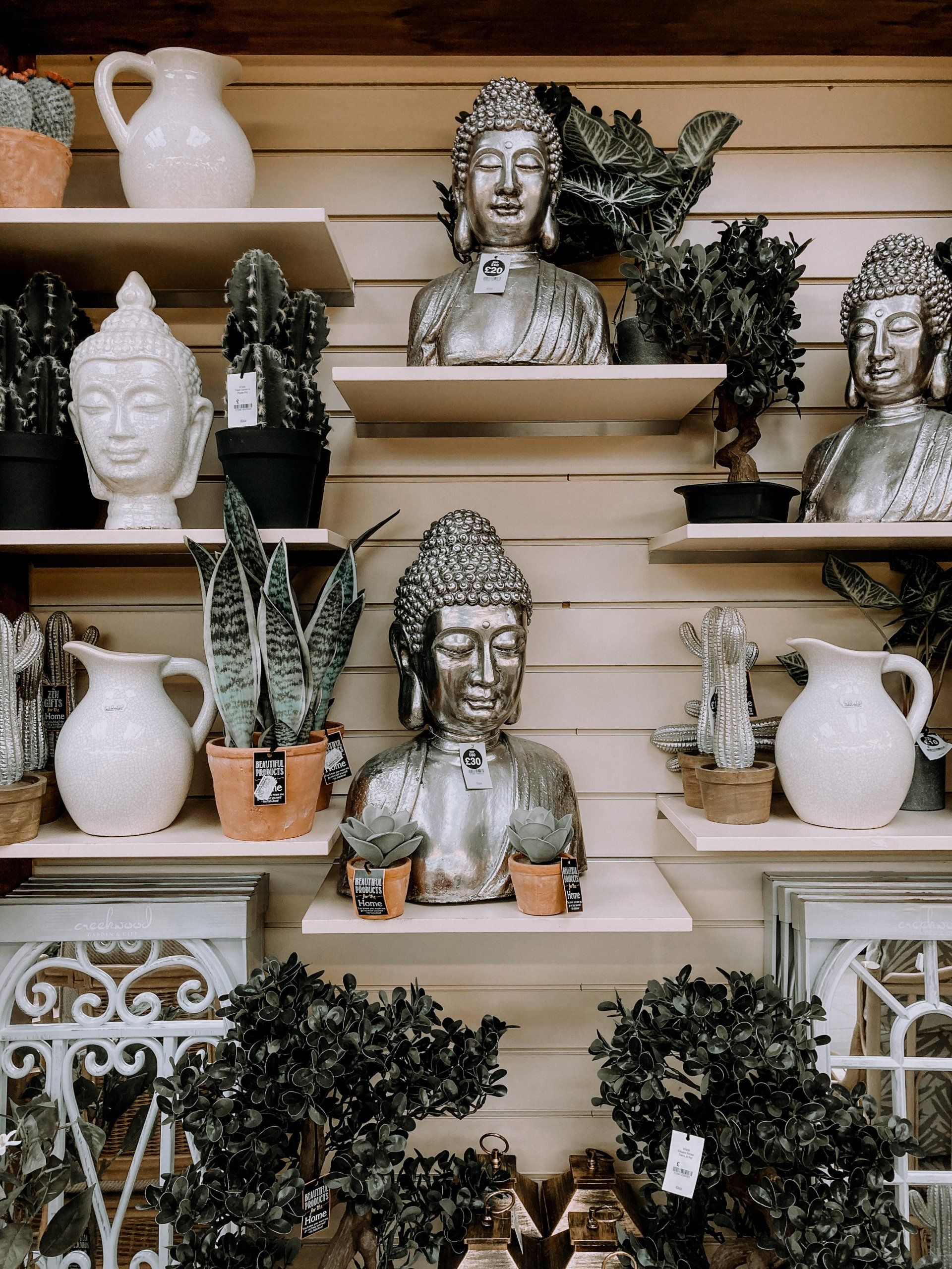 Home interior display for a retailer, with shelves of plants and ornaments
