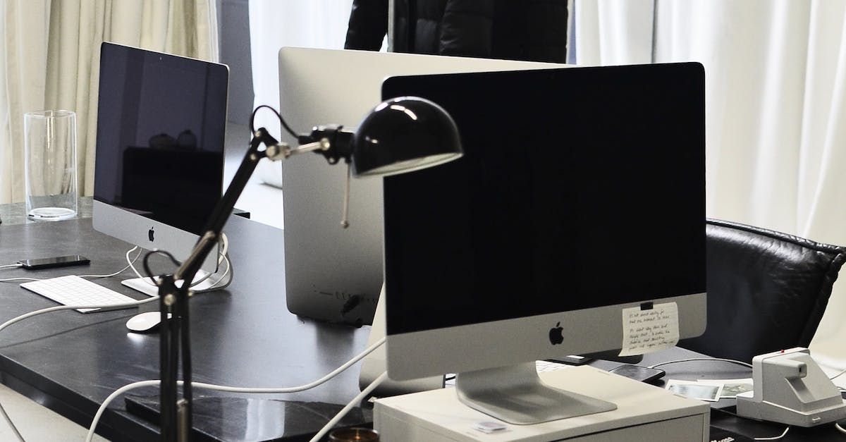 Several computer monitors sitting on a table.