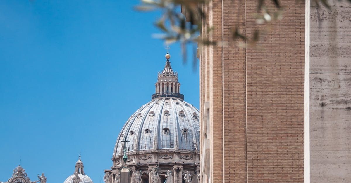 A large building with a dome on top of it and a statue in front of it.