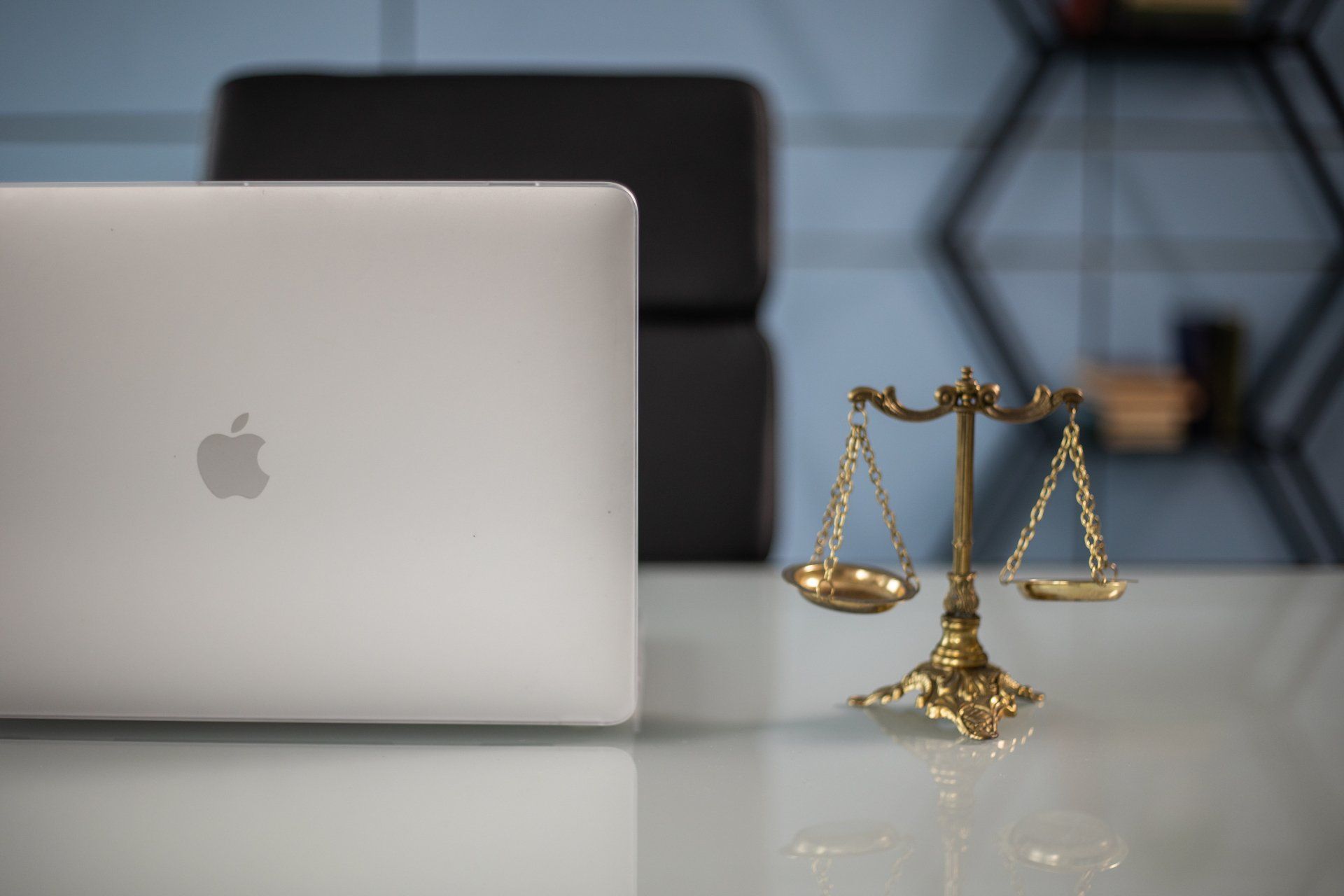 Scales of Justice next to a Laptop.