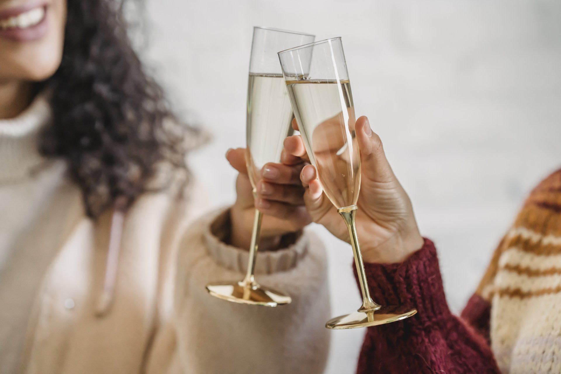 Two women are toasting with champagne glasses.