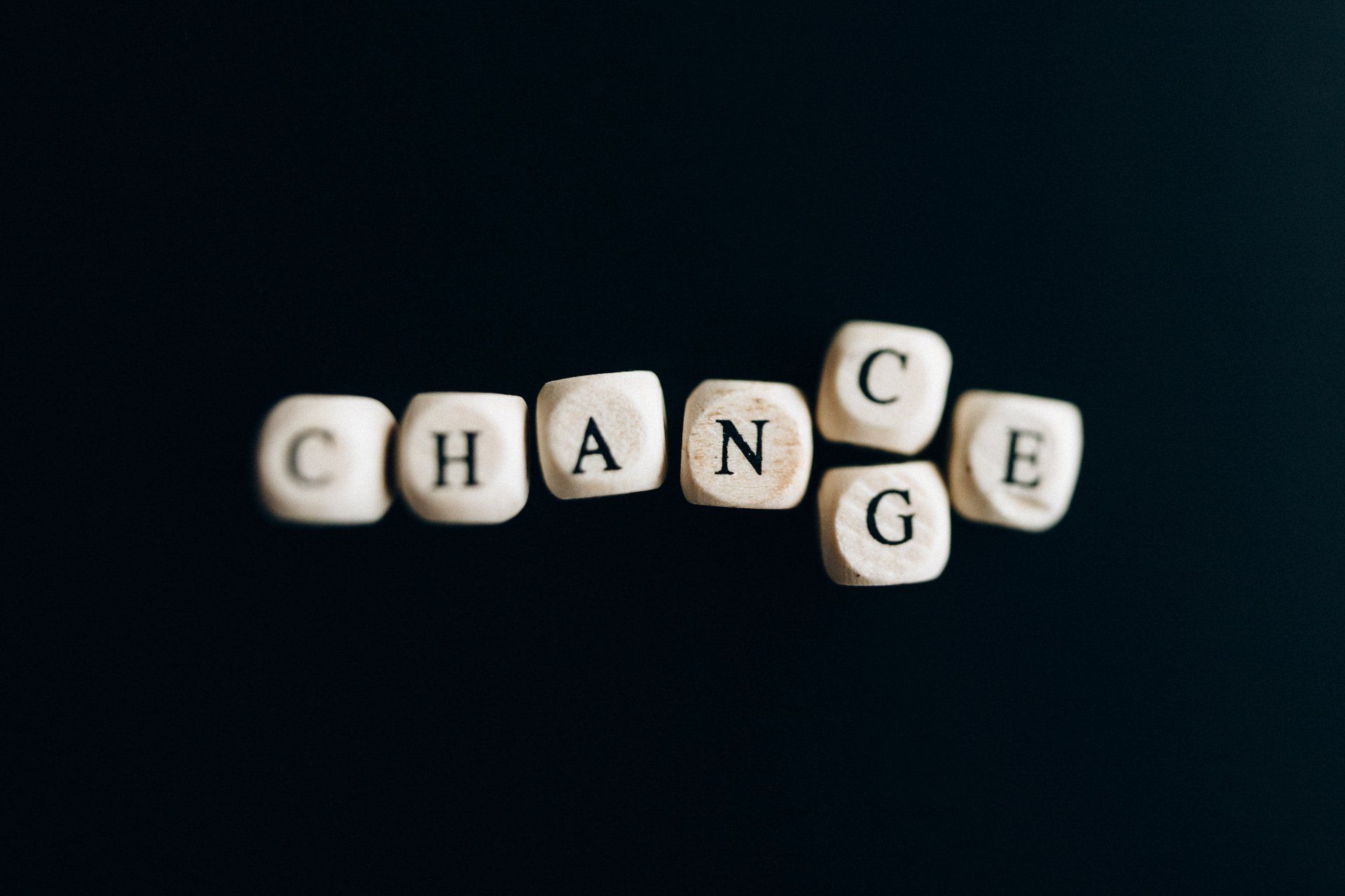 Letters spelling out either chance or change against a black background