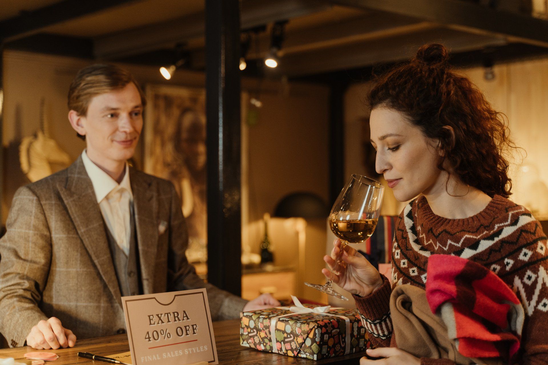 A man and a woman are sitting at a table drinking wine.