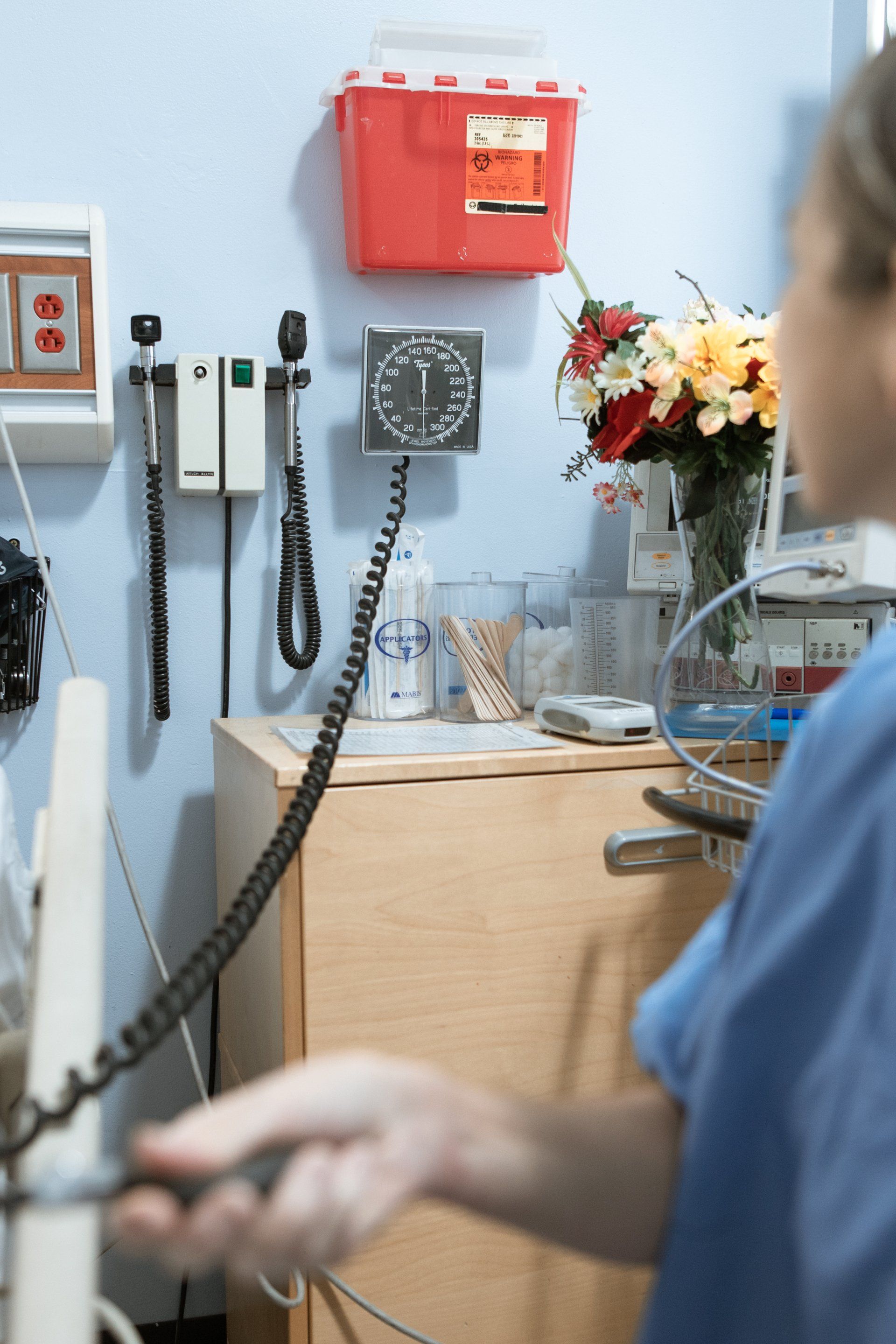 a nurse is talking on a phone in a hospital room .