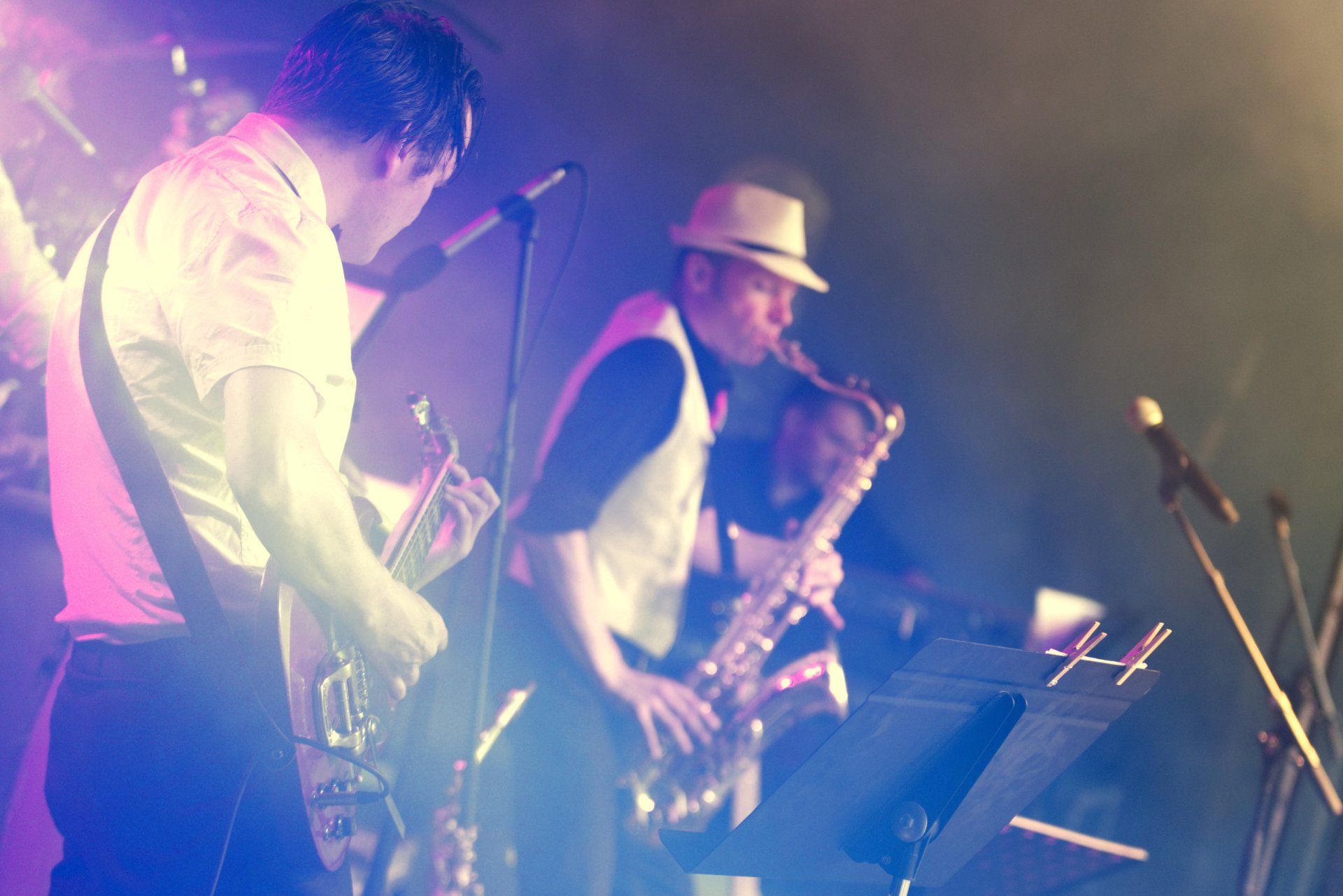 A group of men are playing instruments on a stage.