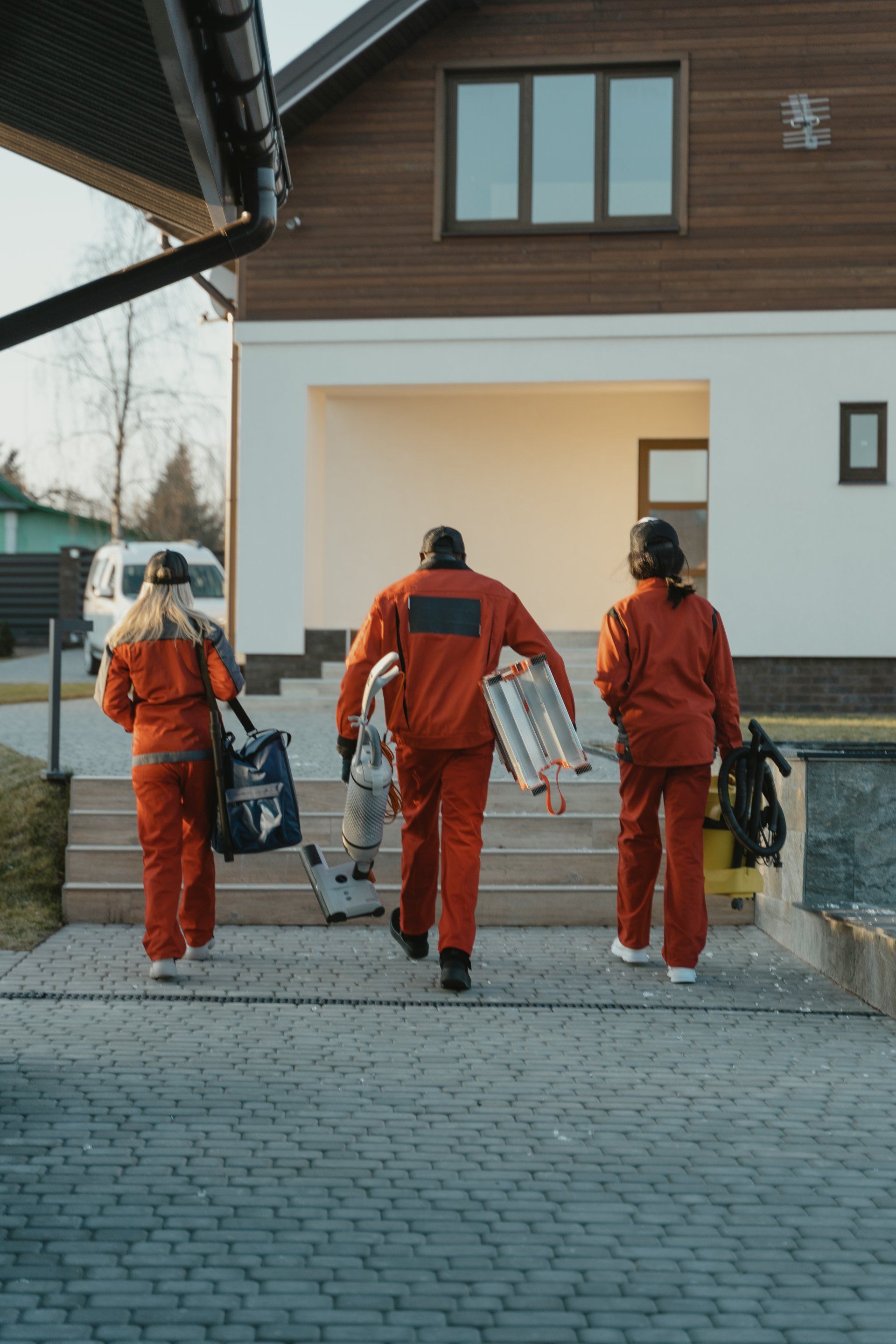 a team of carpet cleaners entering a house