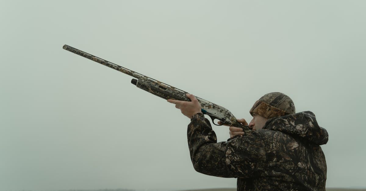 man hunting or shooting in a field