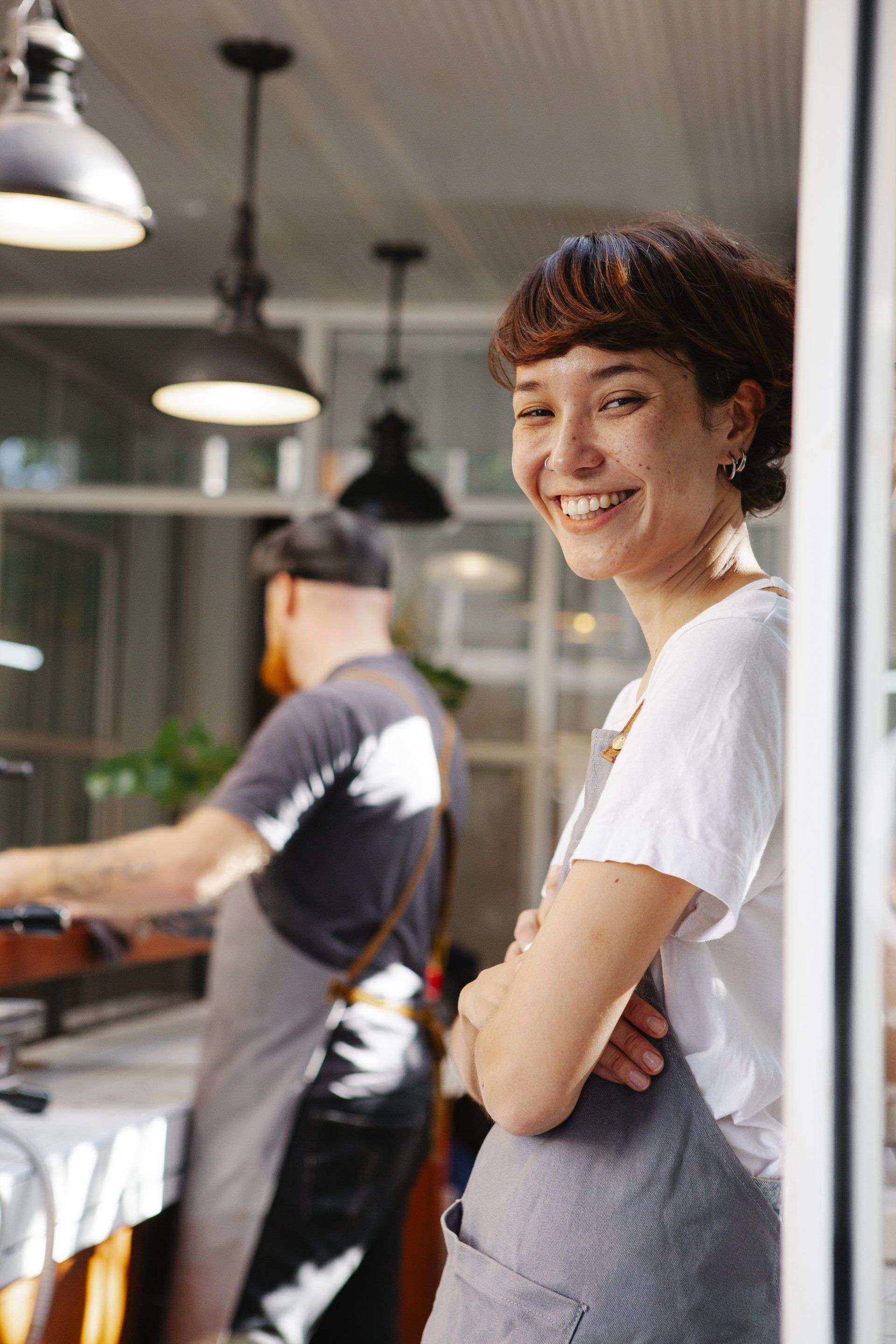 Lady leaning against a coffee shop wall - HR Compliance services