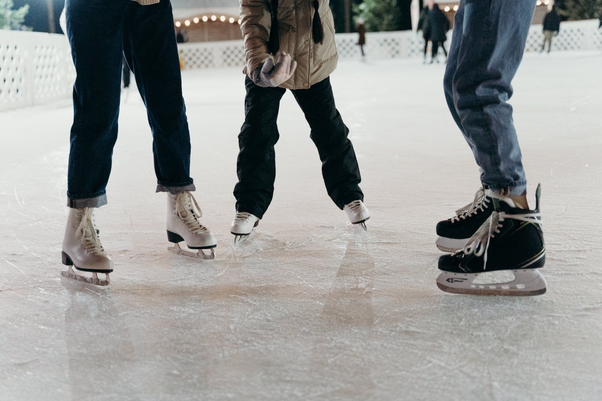 A group of people are ice skating on a rink.