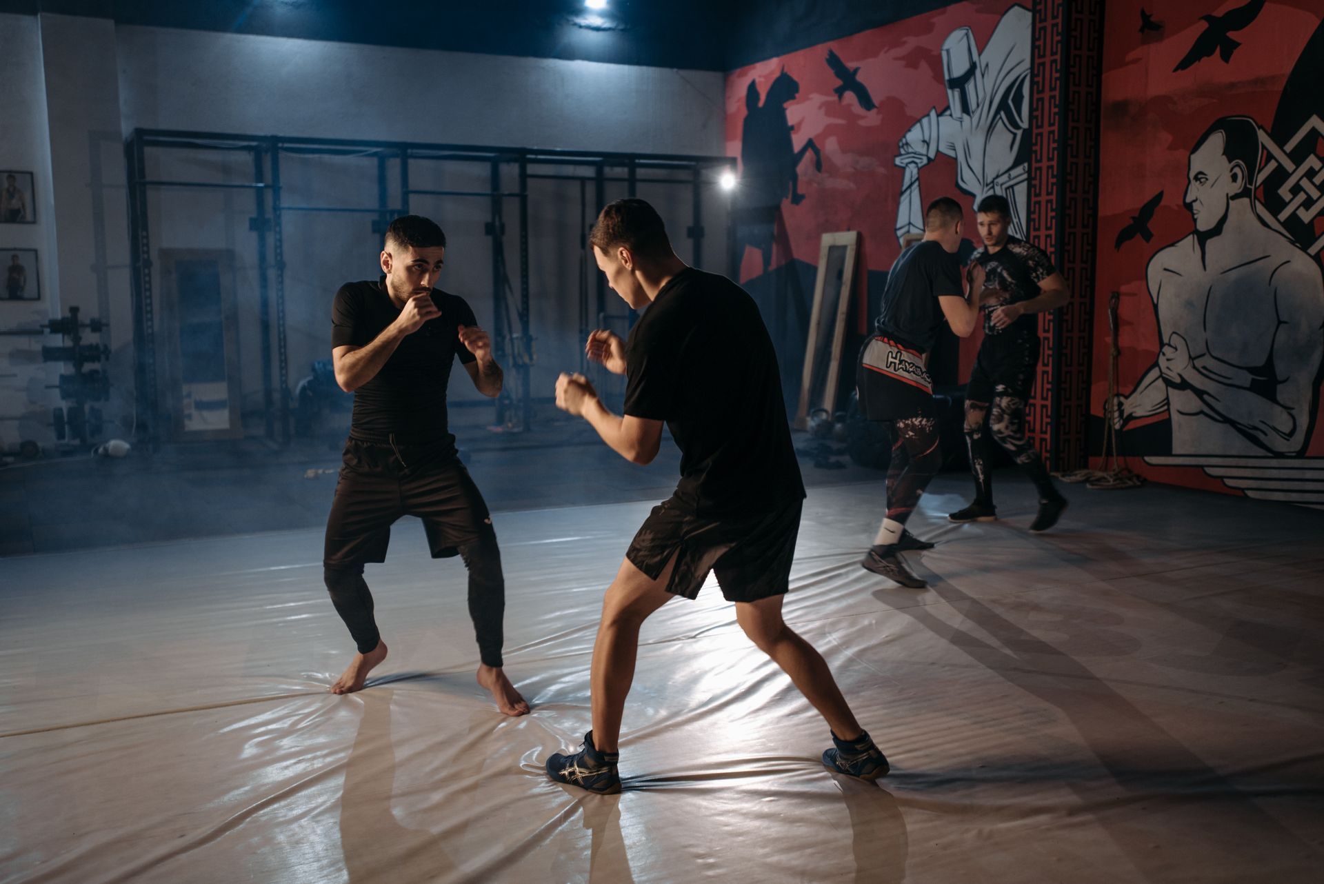 A group of men are practicing martial arts in a gym.