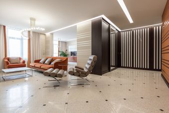 Luxury office space featuring beige tile flooring with black accent tiles throughout.