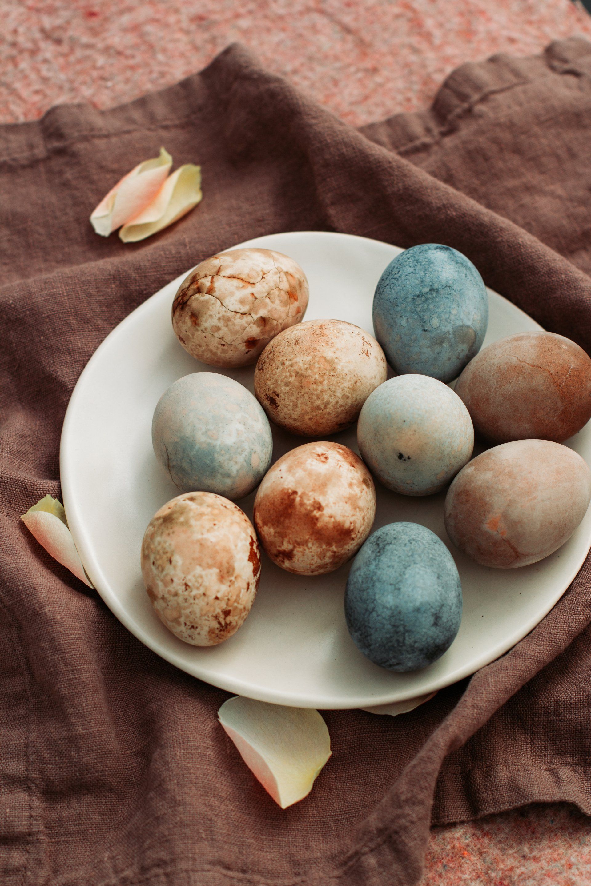 There are many different colored eggs on the plate.