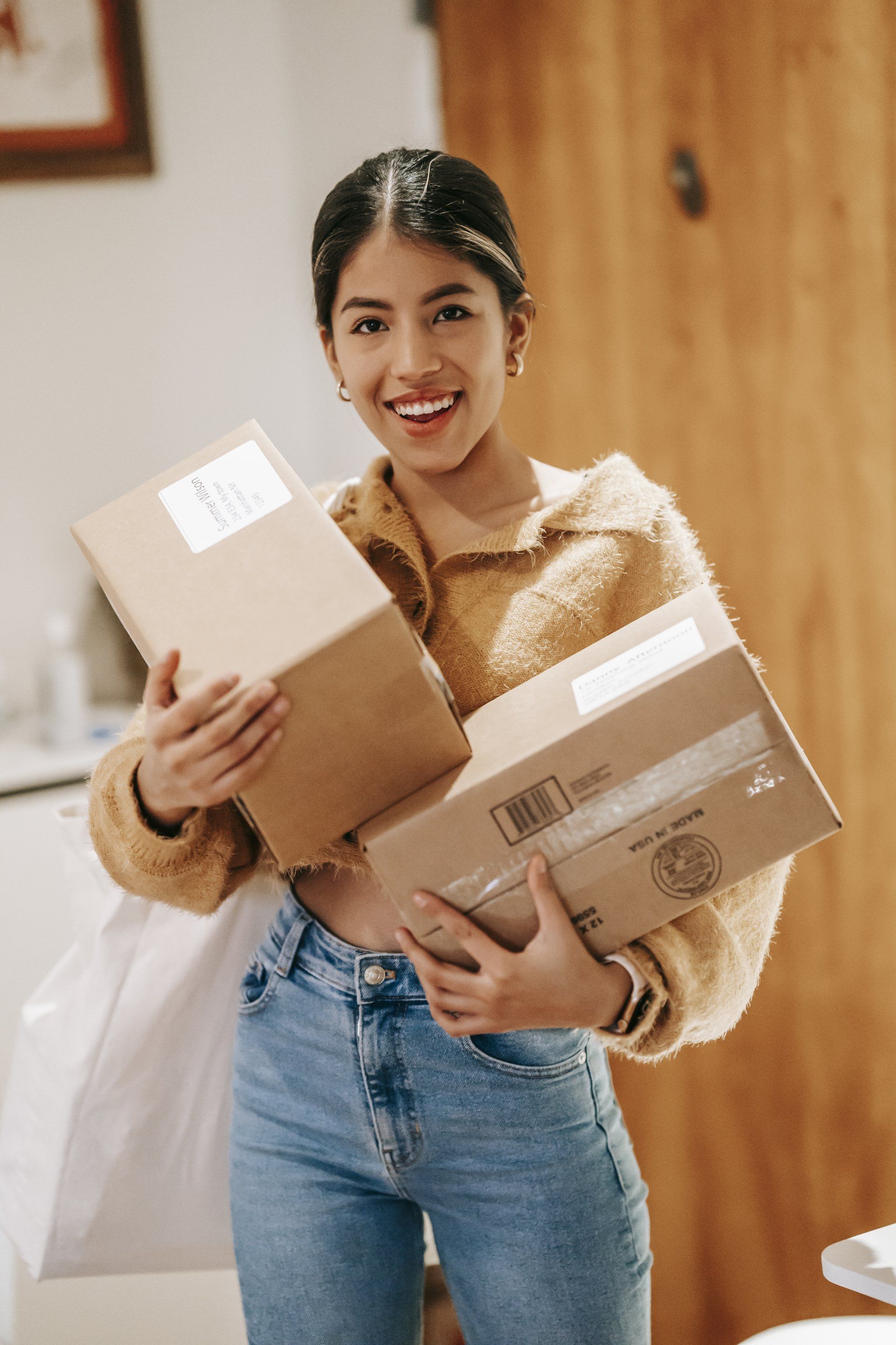 A woman holding boxes delivered via same day courier 