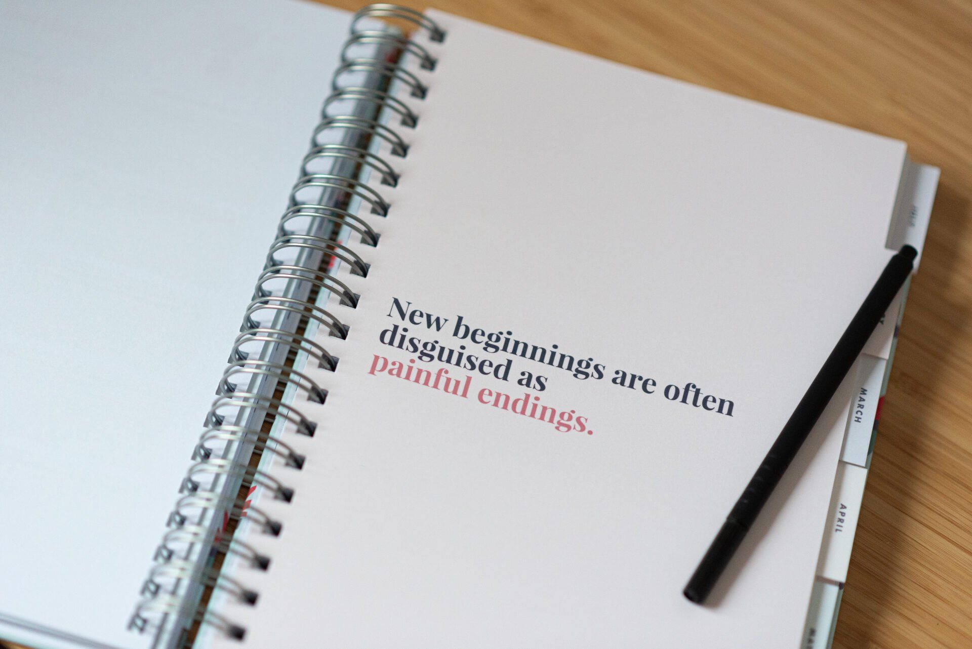 a spiral notebook with a pencil on top of it that says new beginnings are disguised as painful endings