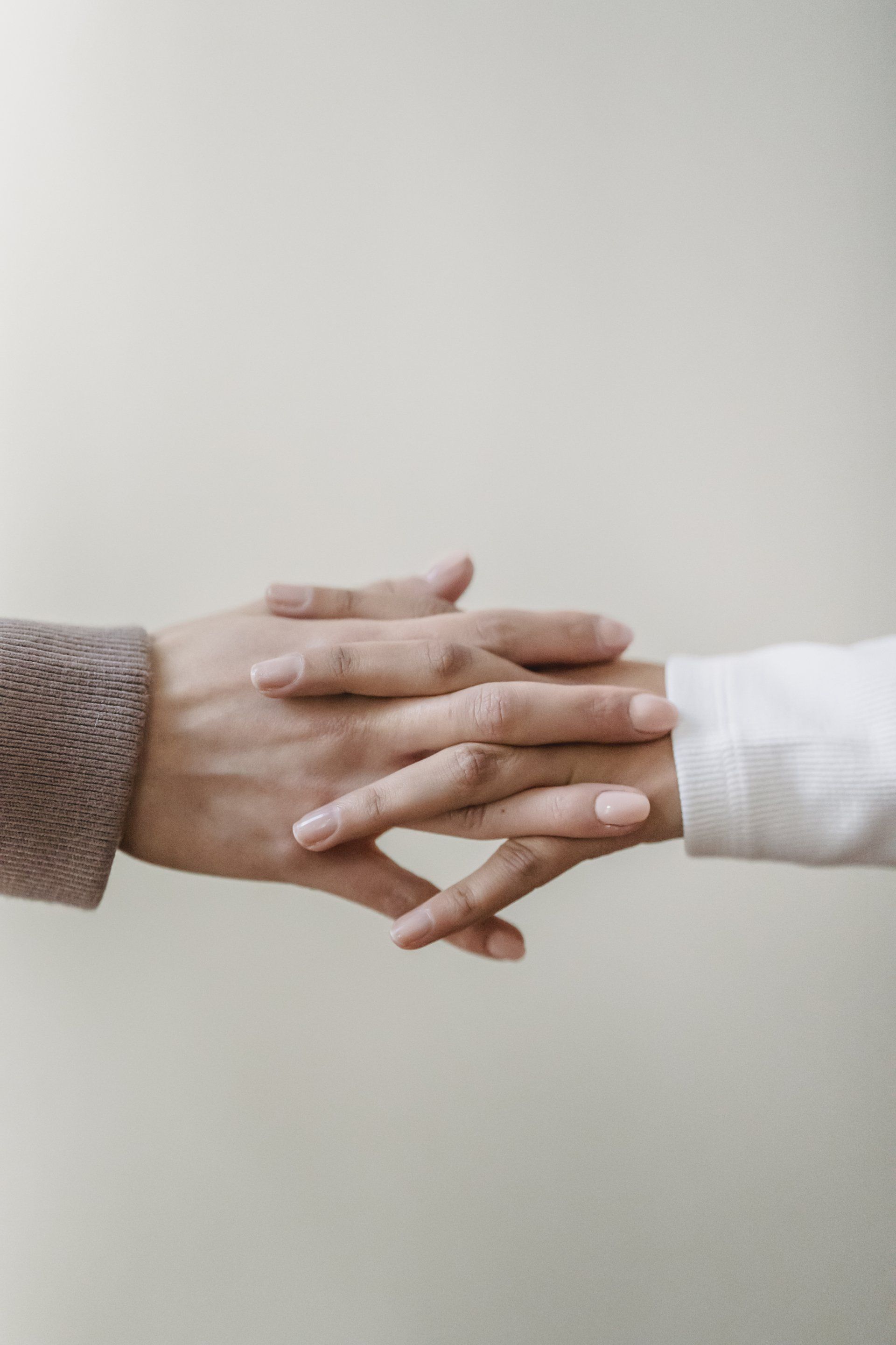 Two hands entwined, symbolising community care and help