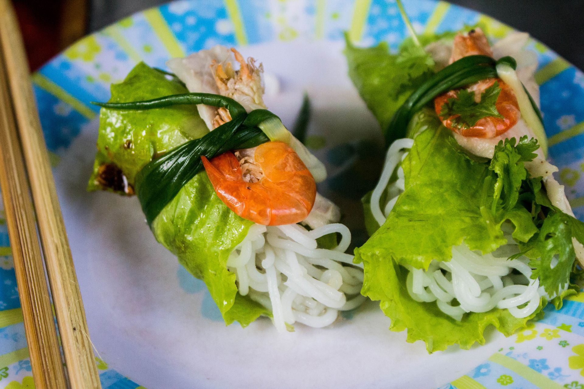 A close up of a plate of food with chopsticks on it.