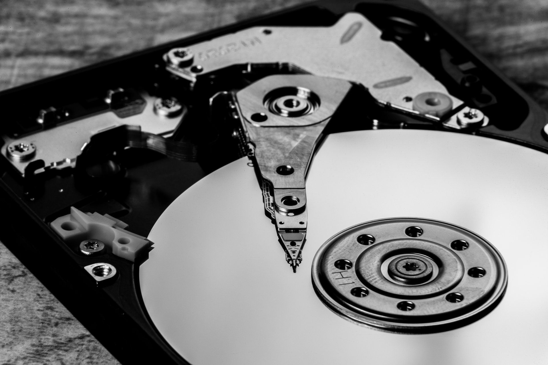 A black and white photo of the inside of a hard drive.