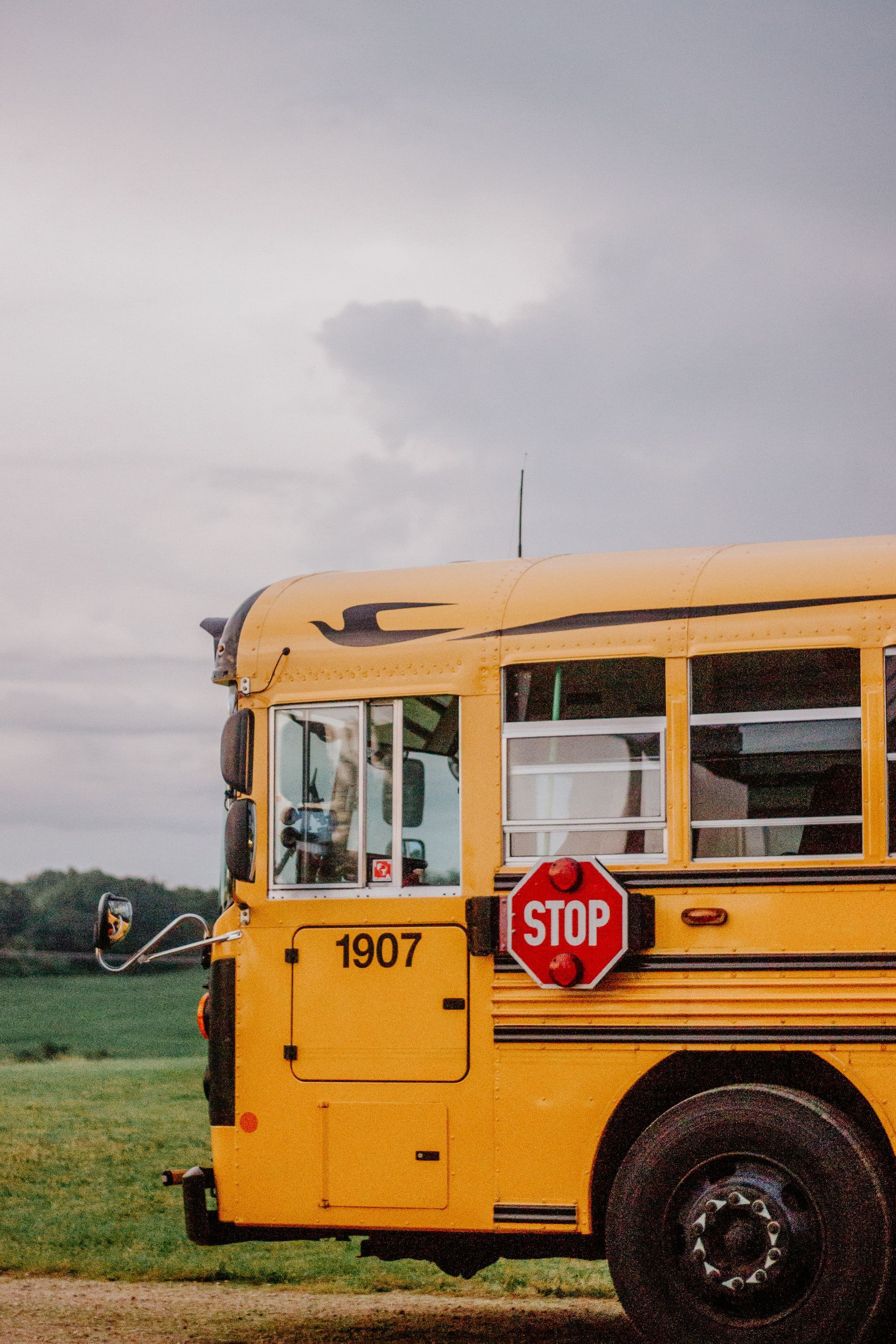 A yellow school bus with a red stop sign on the side