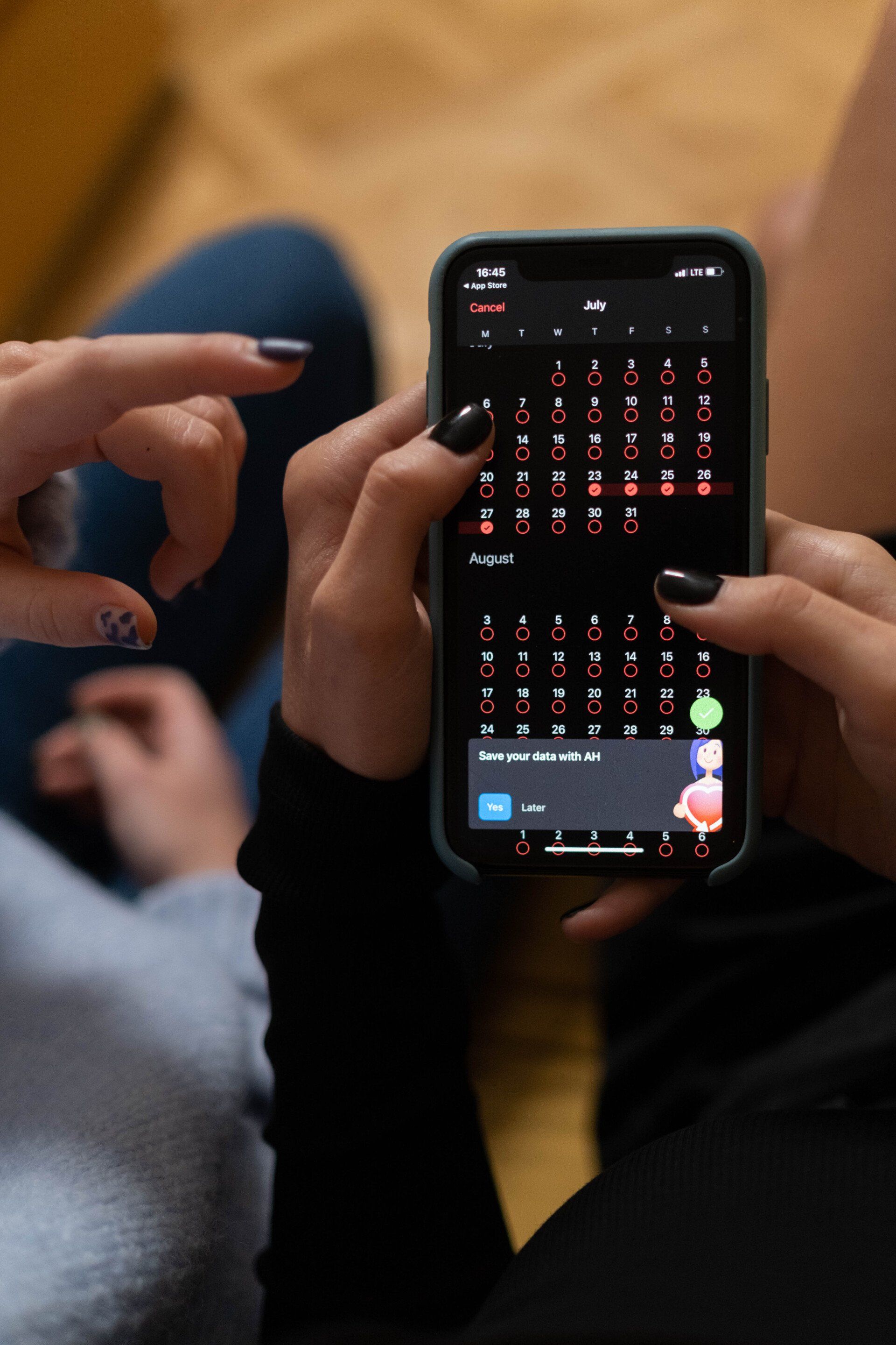 a person is holding a cell phone with a keyboard on it .