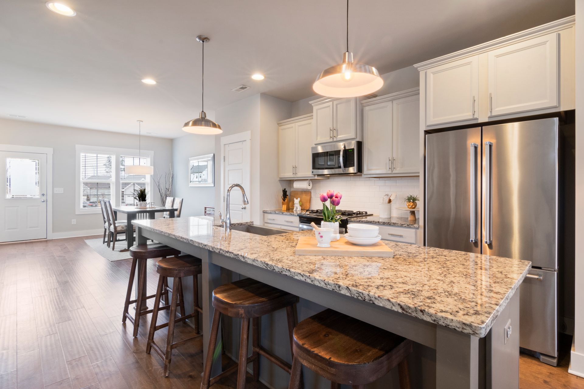 a kitchen with granite counter tops and stainless steel appliances .