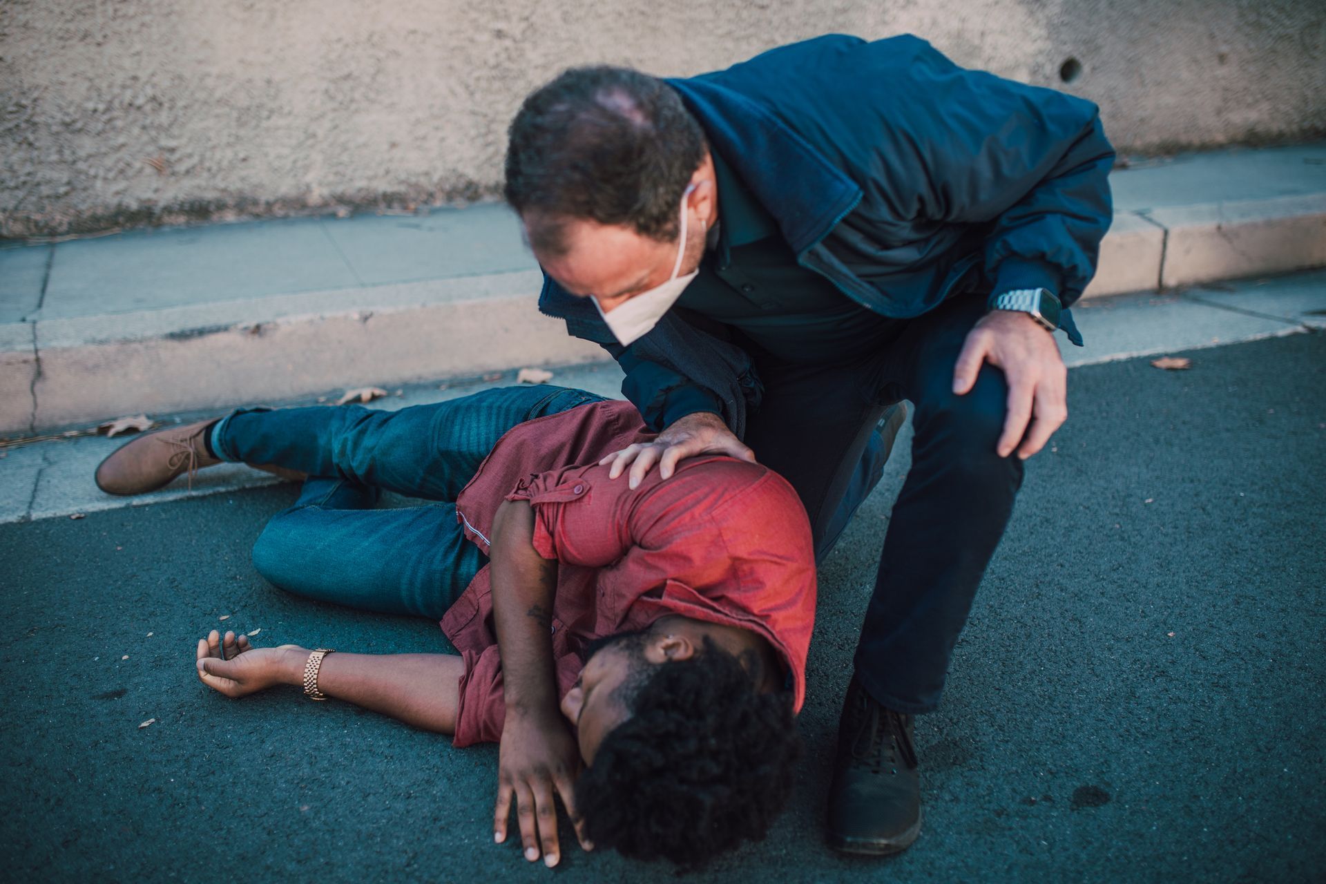 a victim of an accident receiving medical care while lying on the ground