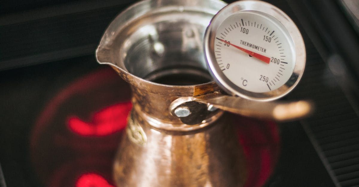 a scoville scale thermometer is sitting on top of a pot on a stove .