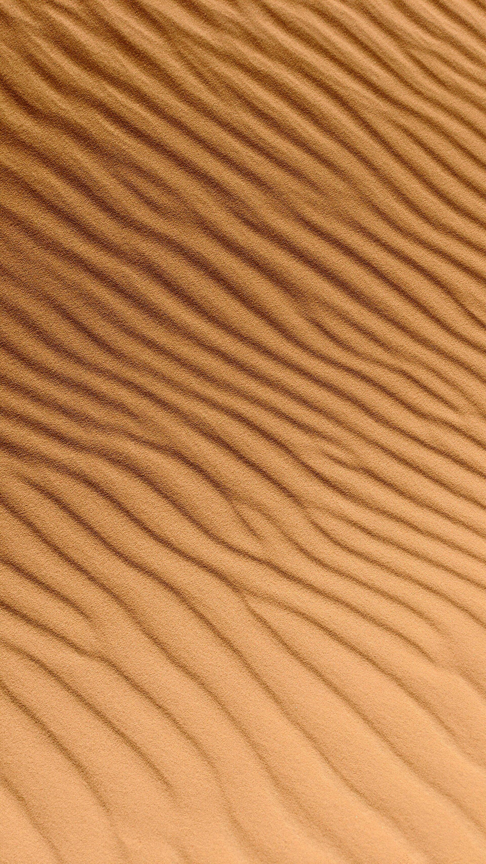 A close up of a pile of sand with a striped pattern.