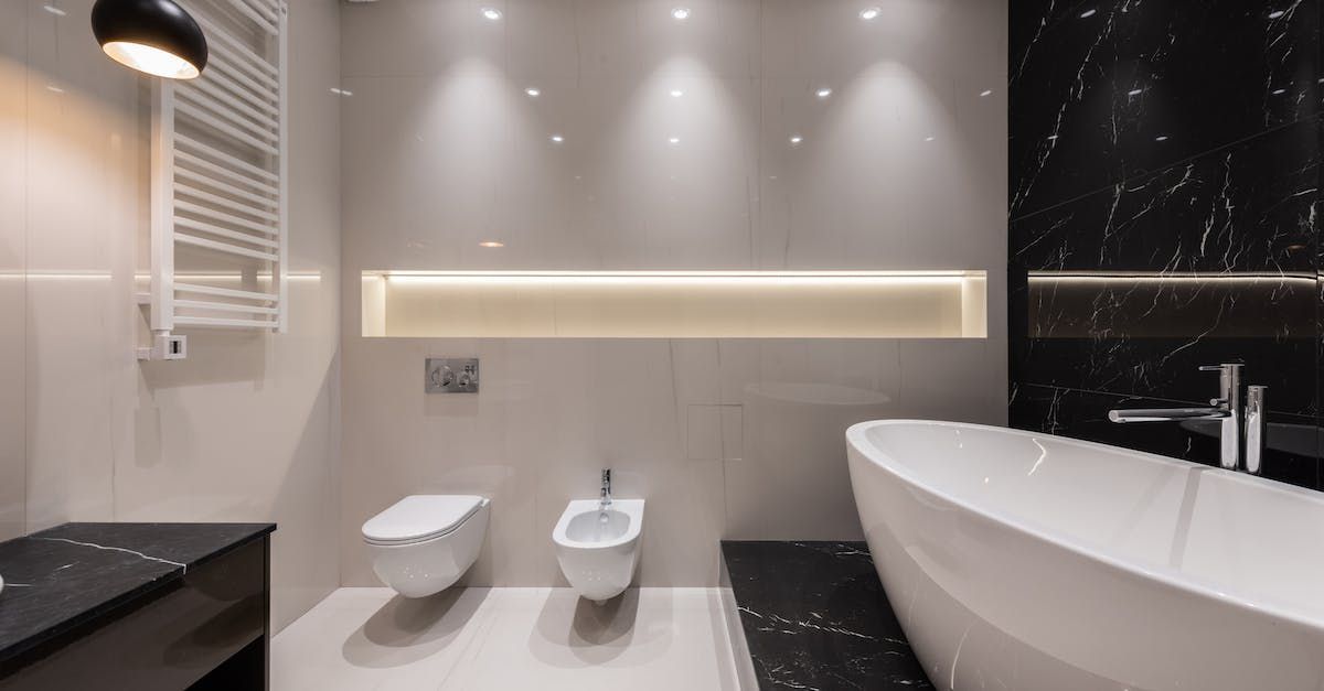 a bathroom with a bathtub , toilet and bidet .