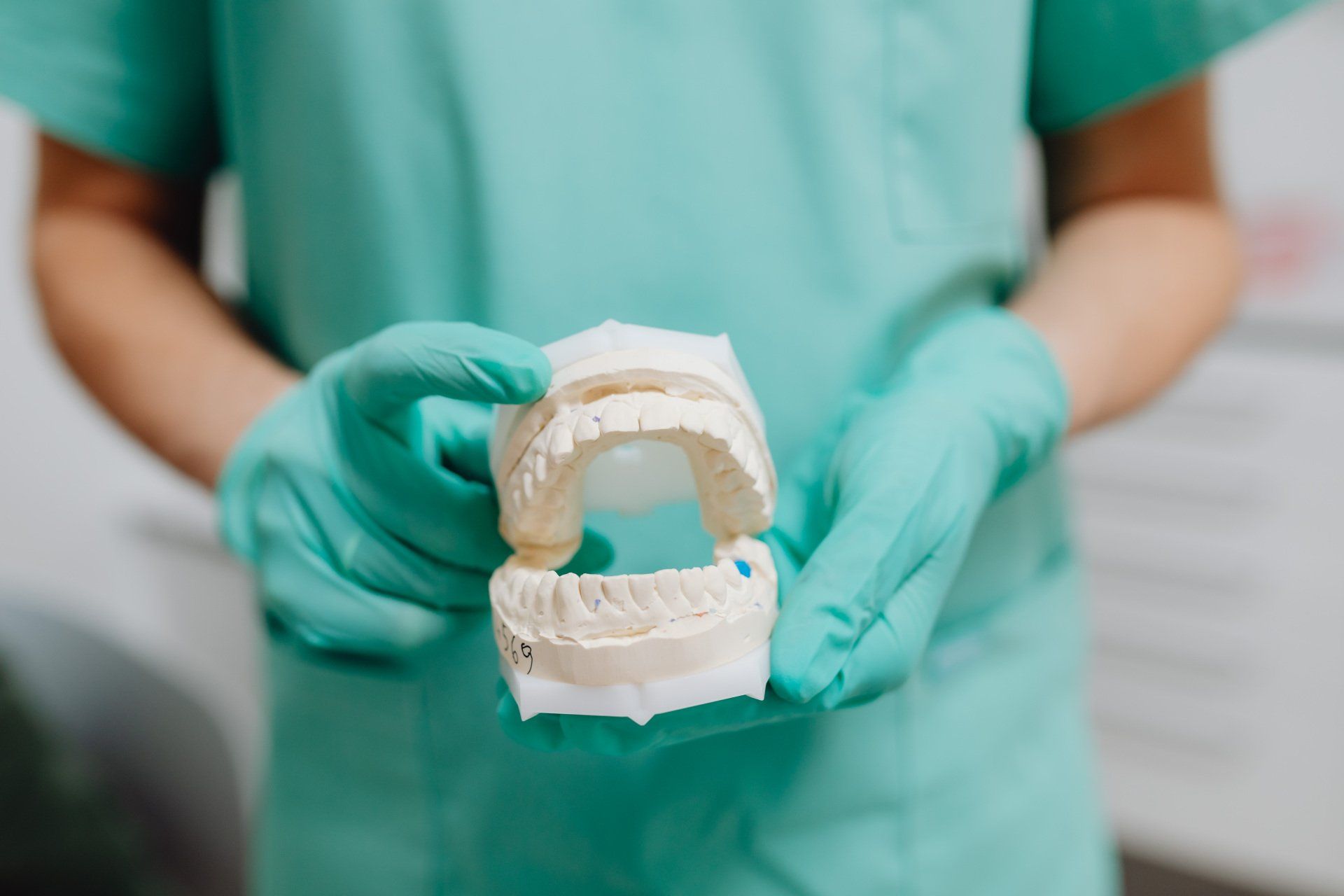 dentist holding denture mold
