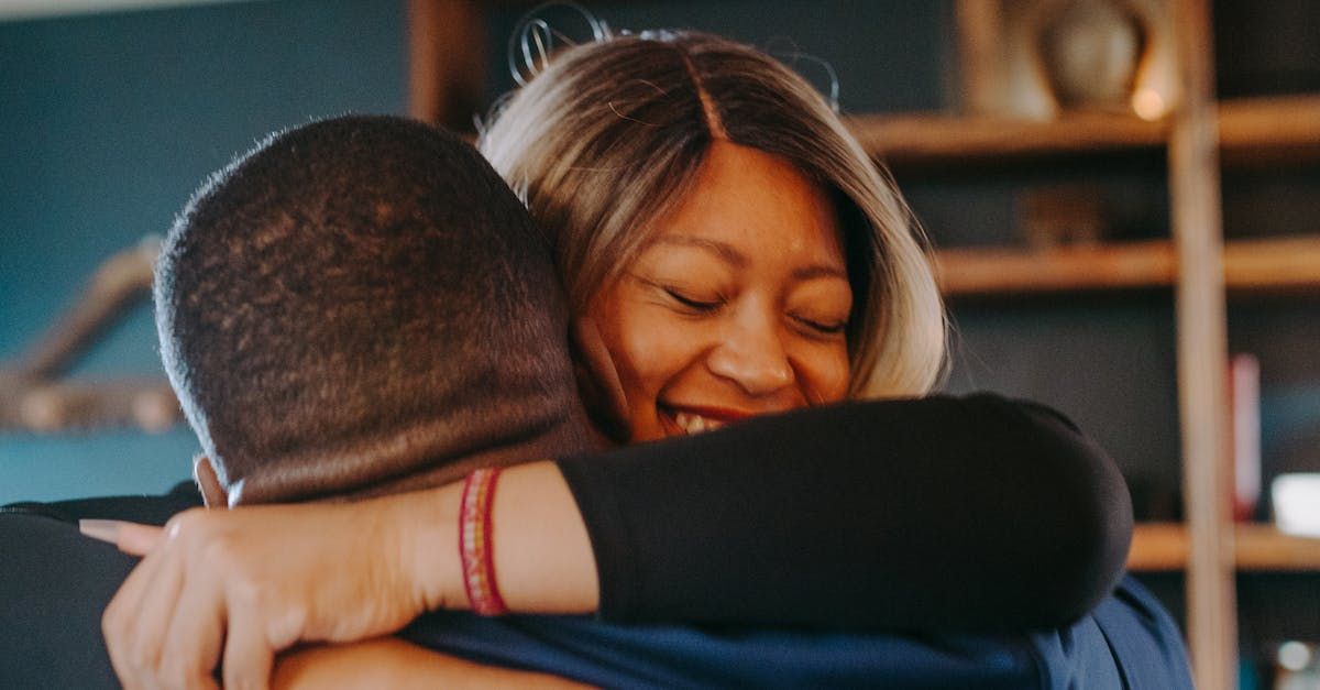 Engaged couples hugging and smile, connecting using The Gottman Method marriage preparation counseling in Grapevine Texas