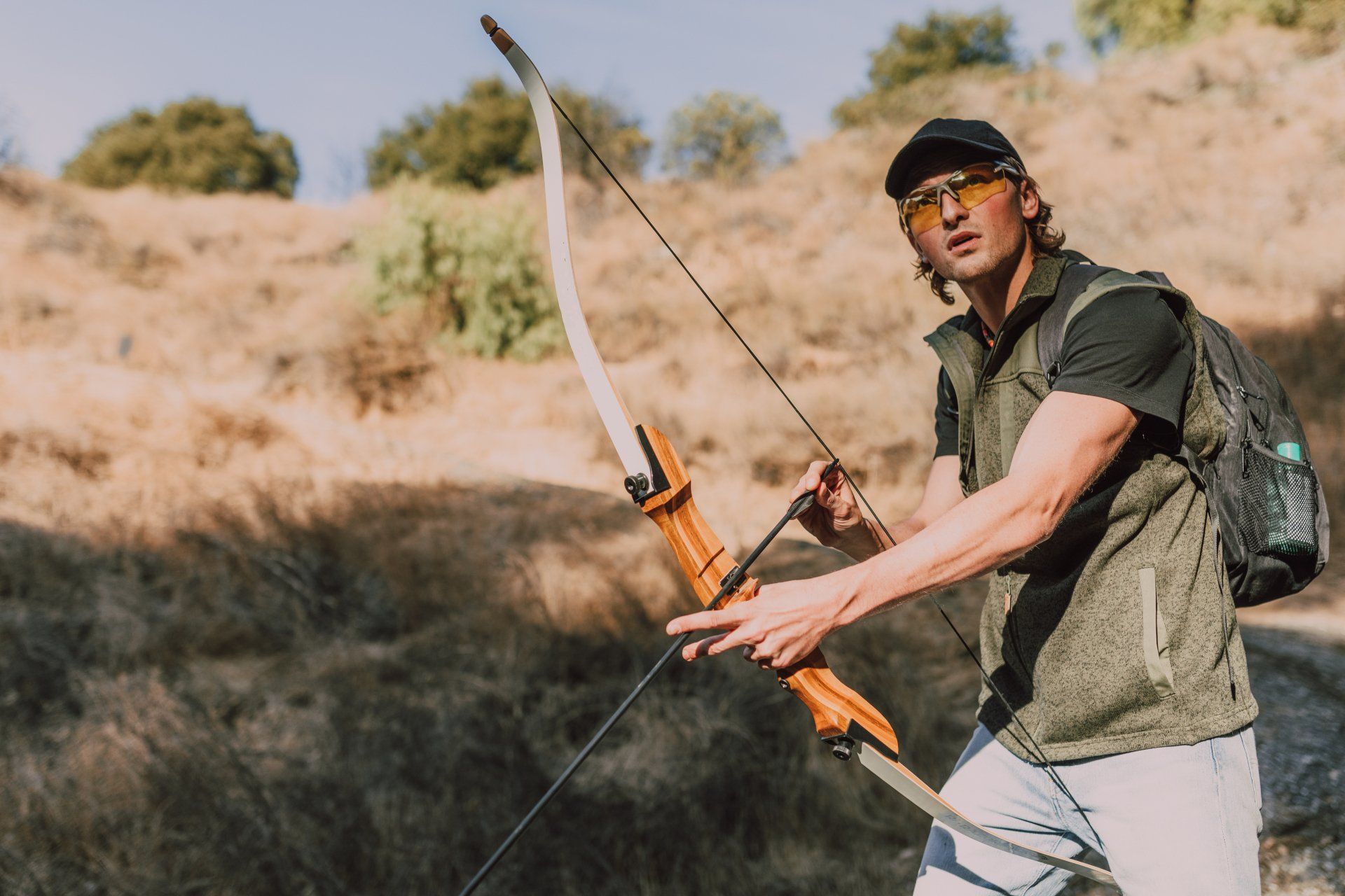 a man holding a bow on an archery range