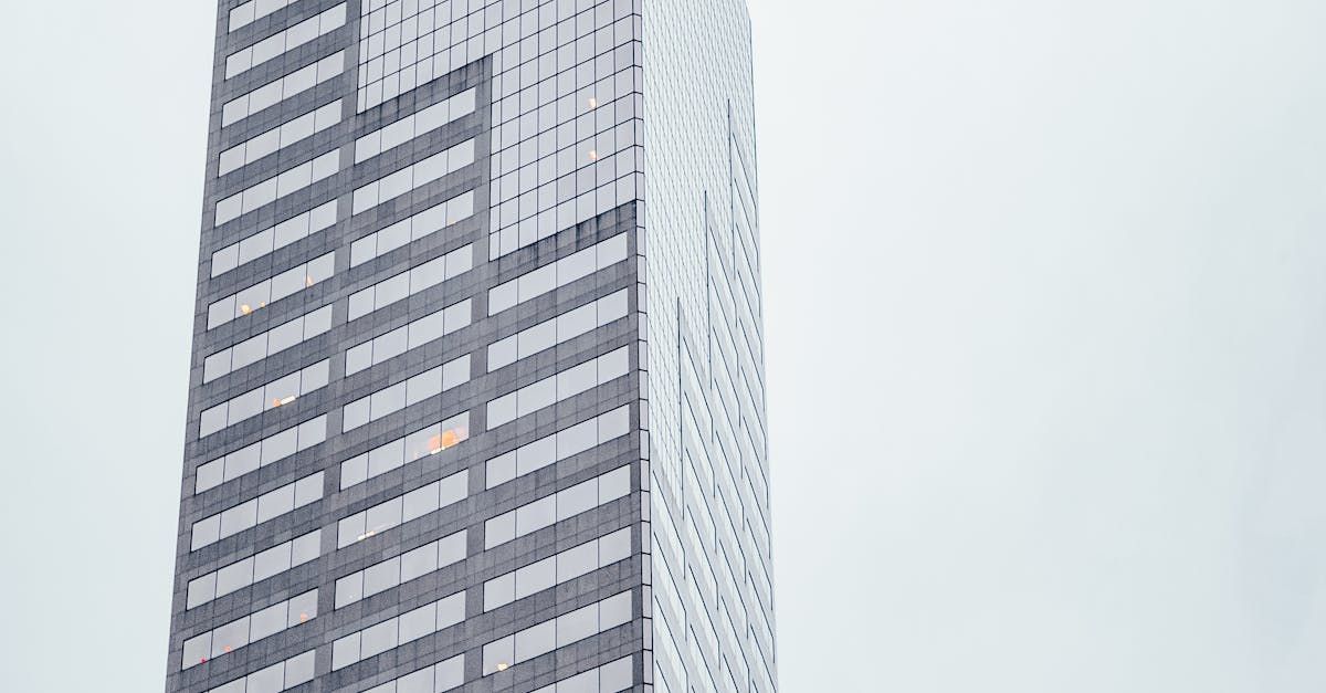 The sun is shining through the windows of a tall building.