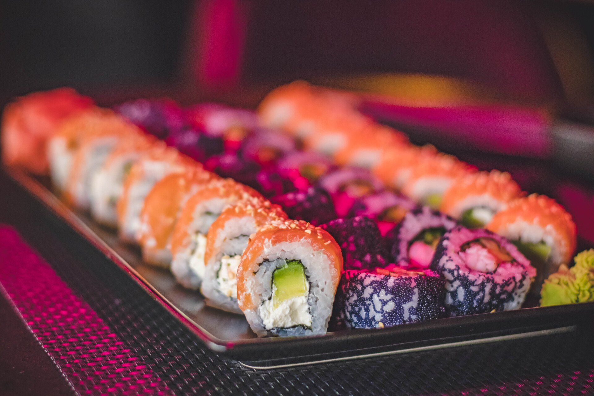 A close up of a plate of sushi on a table.