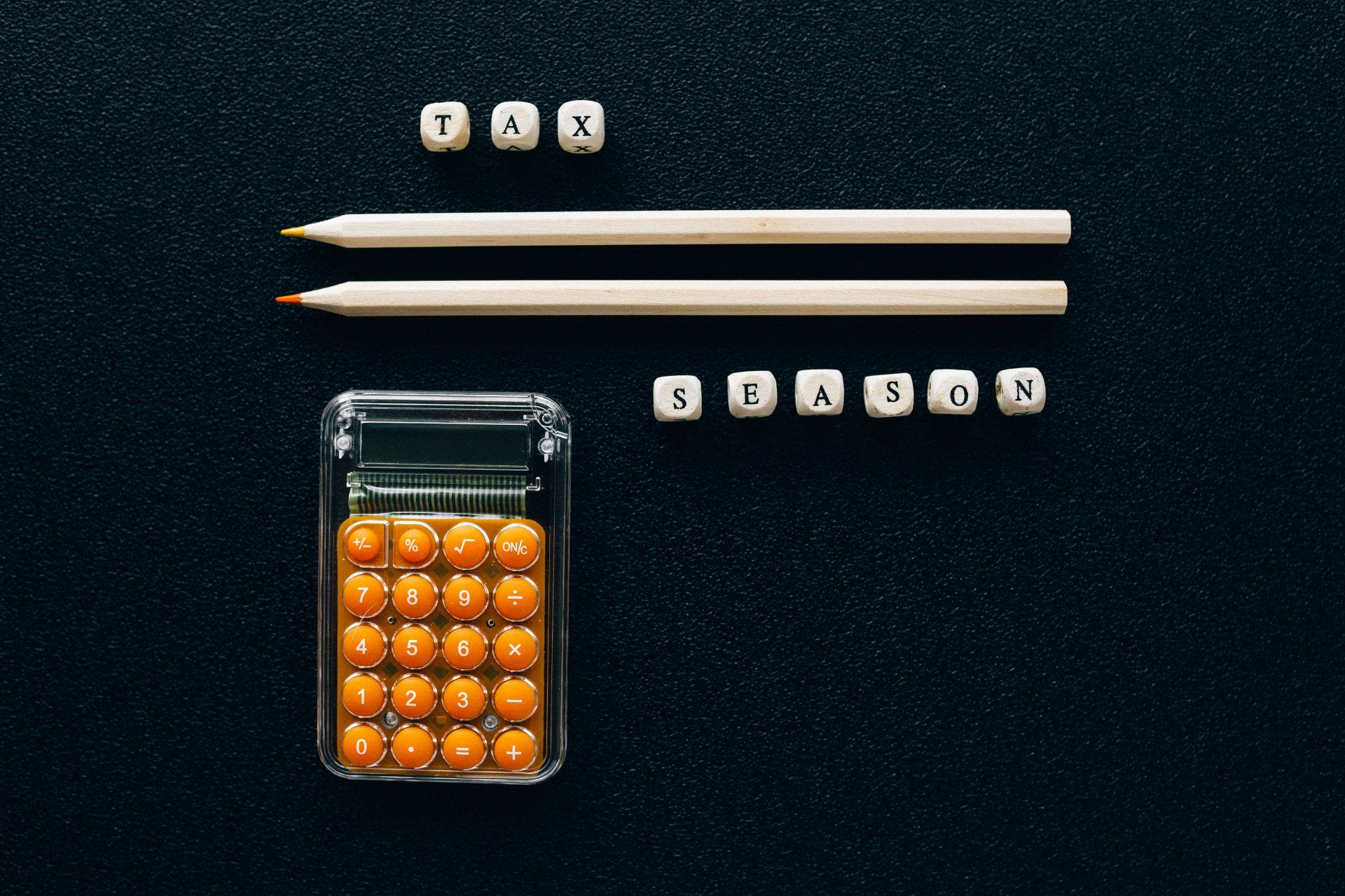 Image of calculator and pencil with words tax season