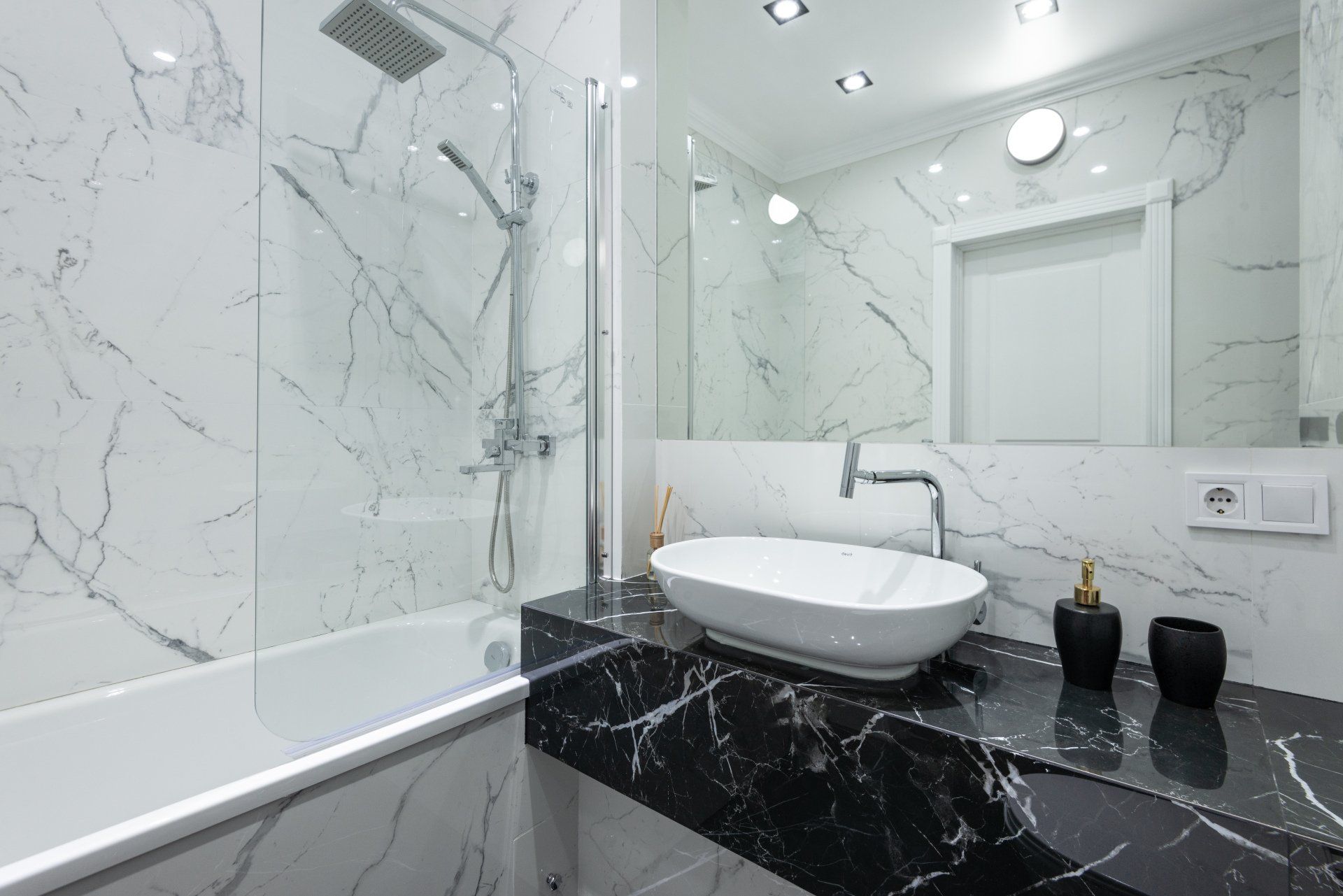 Marble bathroom with glass shower and tub