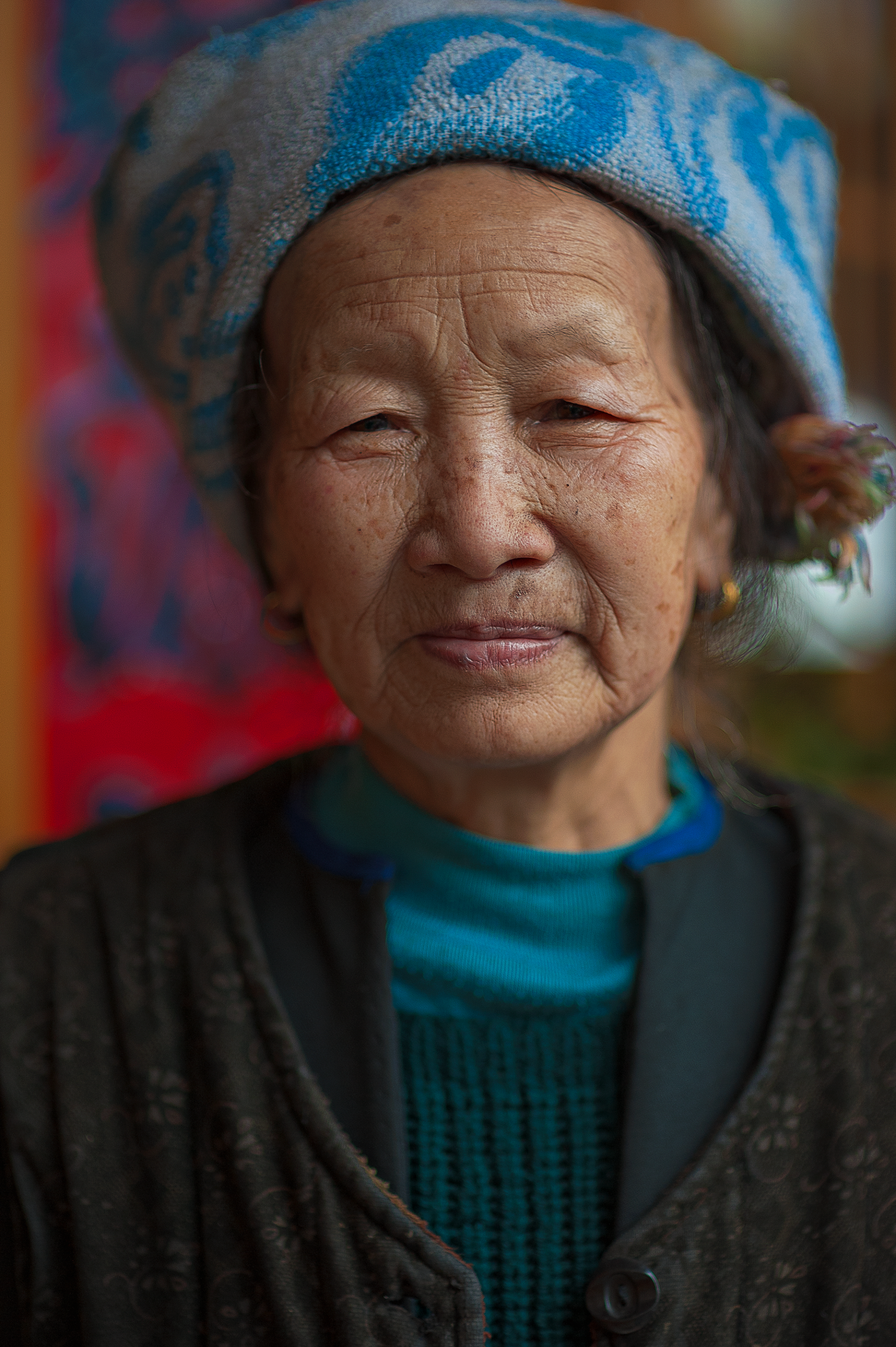 A close up of a woman wearing a blue hat.