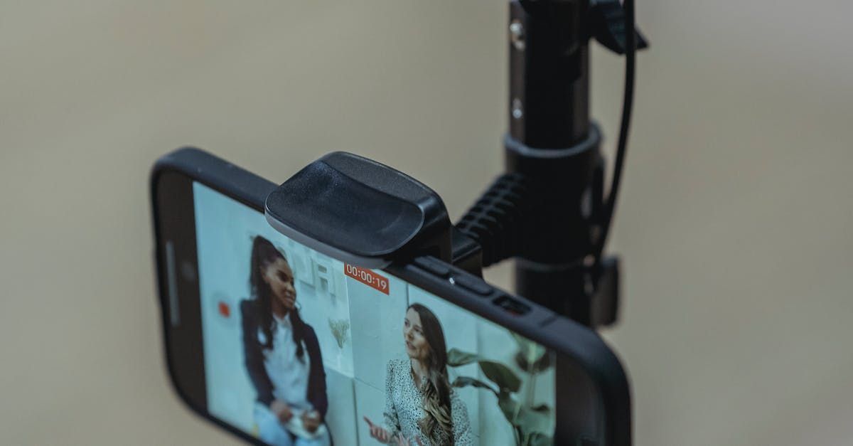 A close up of a cell phone on a tripod.