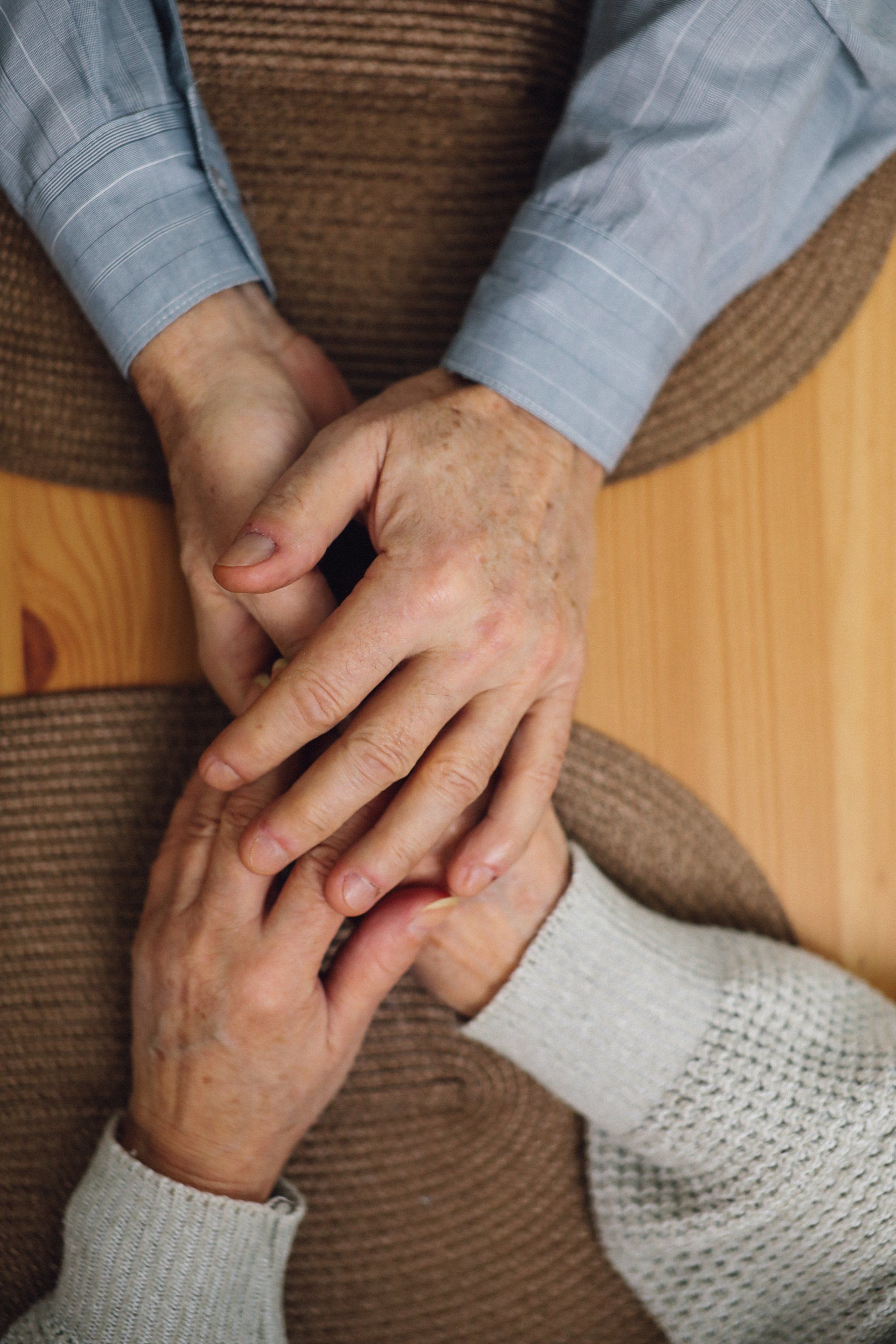 A man and a woman are holding hands at a table.