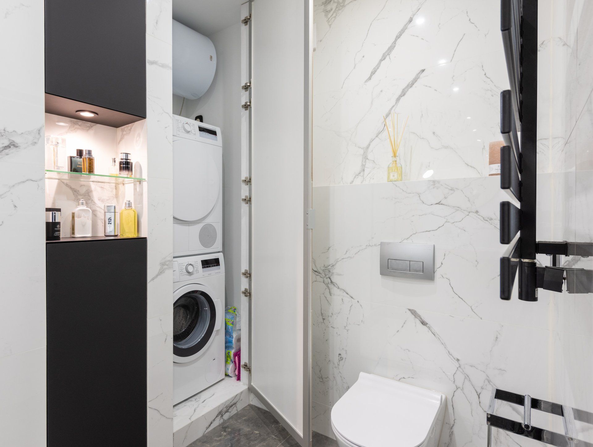 a washer and dryer combo unit in a bathroom closet