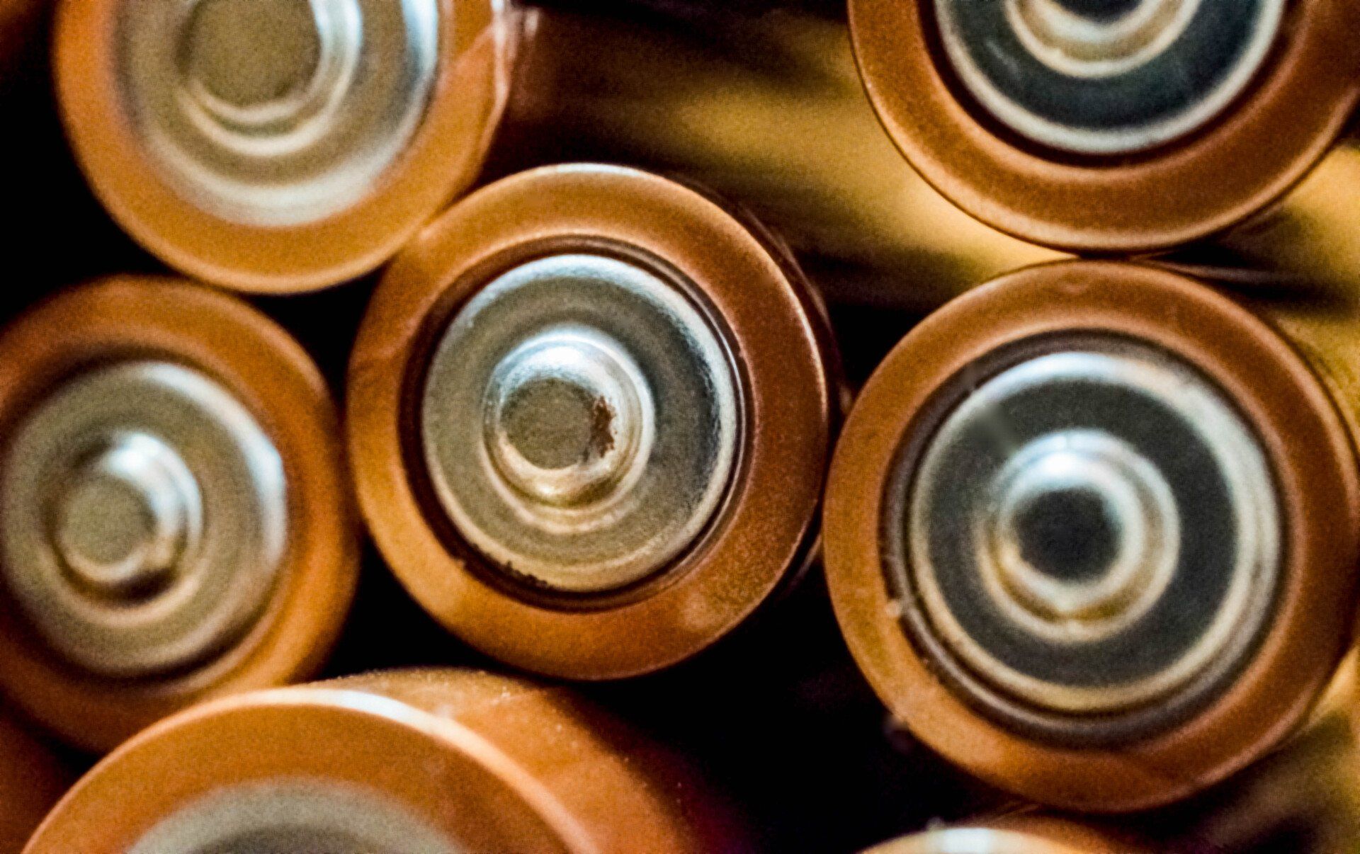 a bunch of batteries are stacked on top of each other .