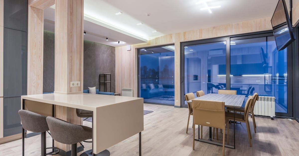 There is a table and chairs in the middle of the room.